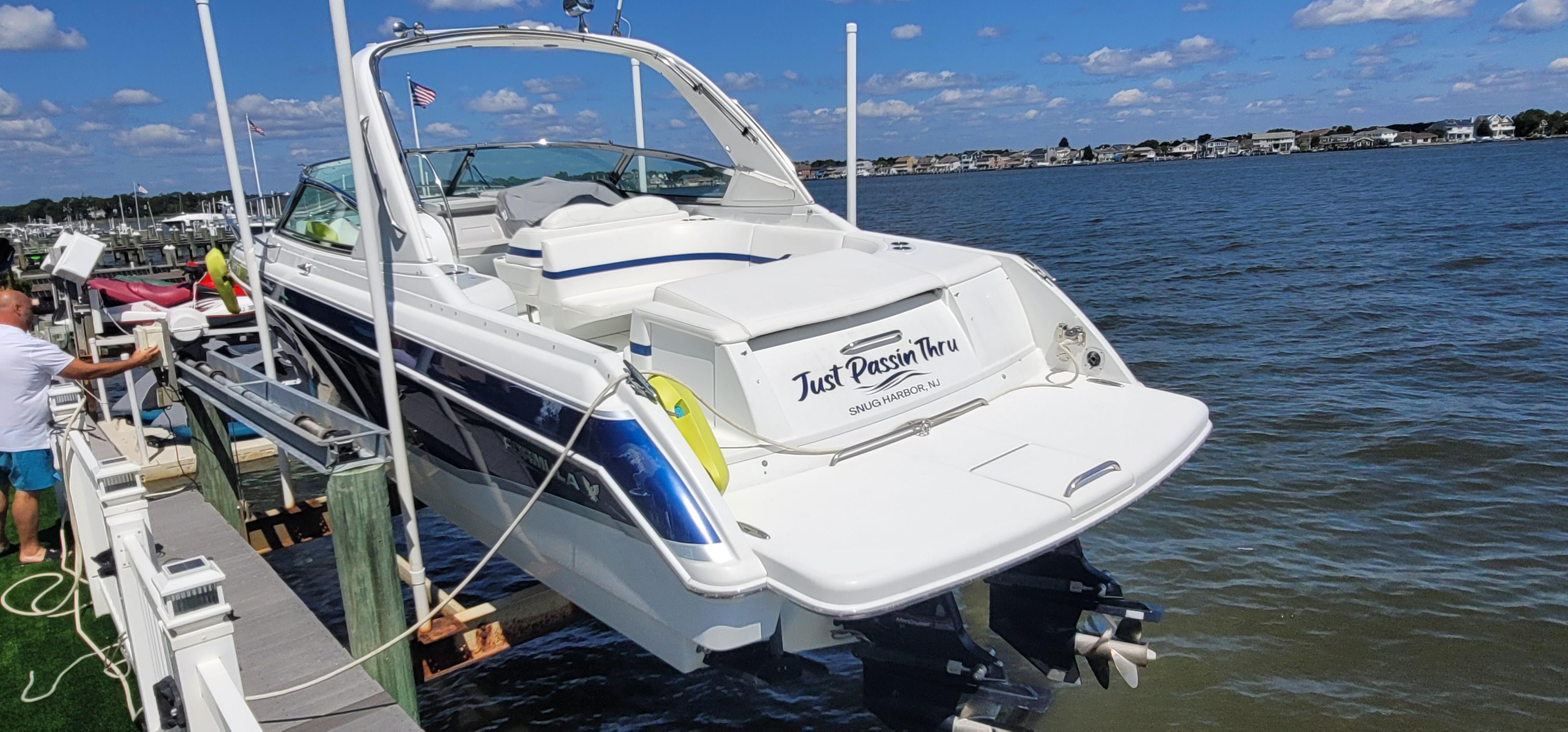 2007 Formula 330 Sun Sport boat docked by the water on a sunny day.