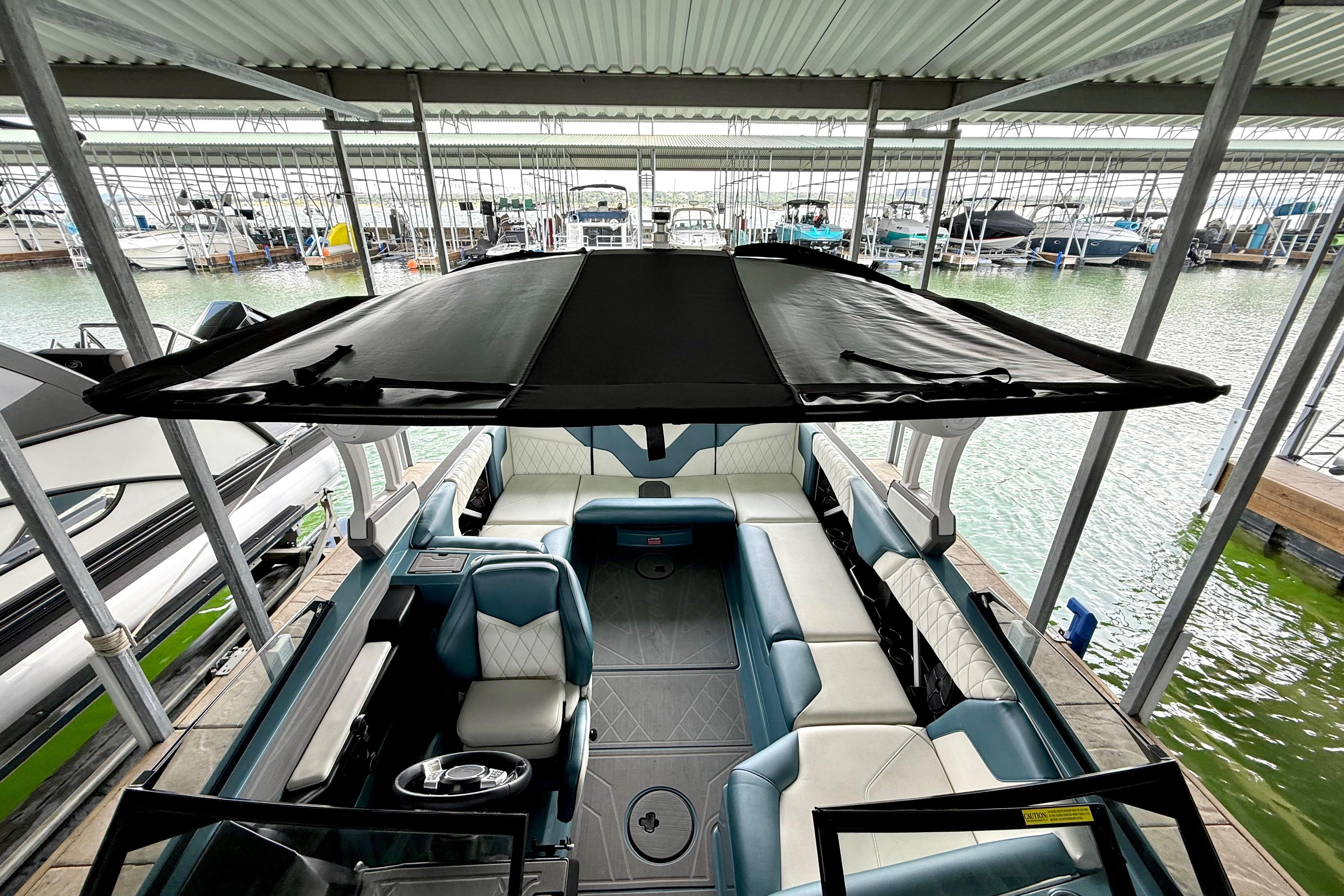 2021 Tige Z3 boat with canopy, docked in a marina.