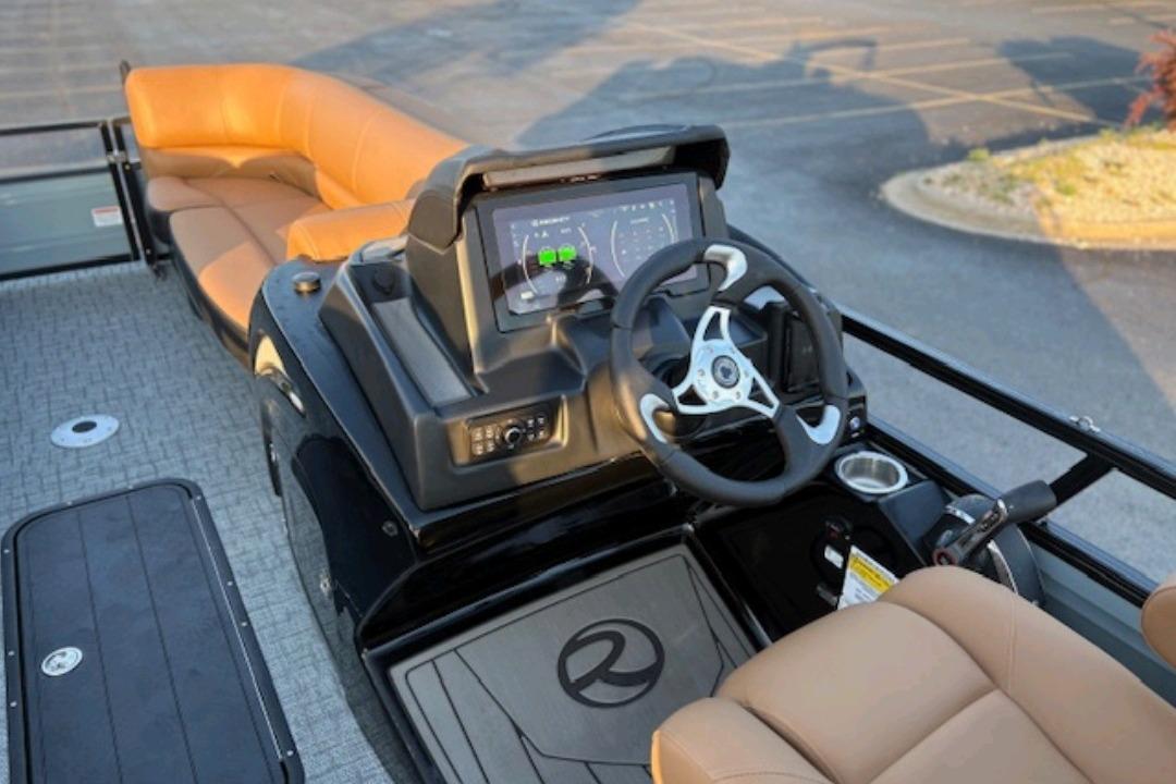 2026 Regency 230 DL boat interior with modern dashboard and tan seating.