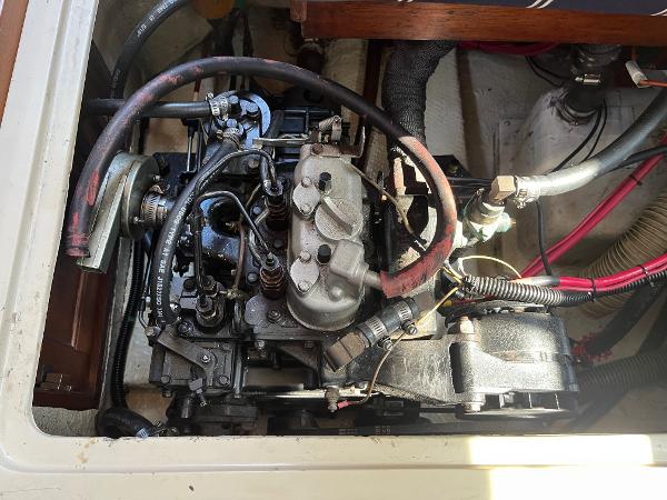 Engine compartment of a 1980 Catalina 30 sailboat, showing detailed mechanical components.