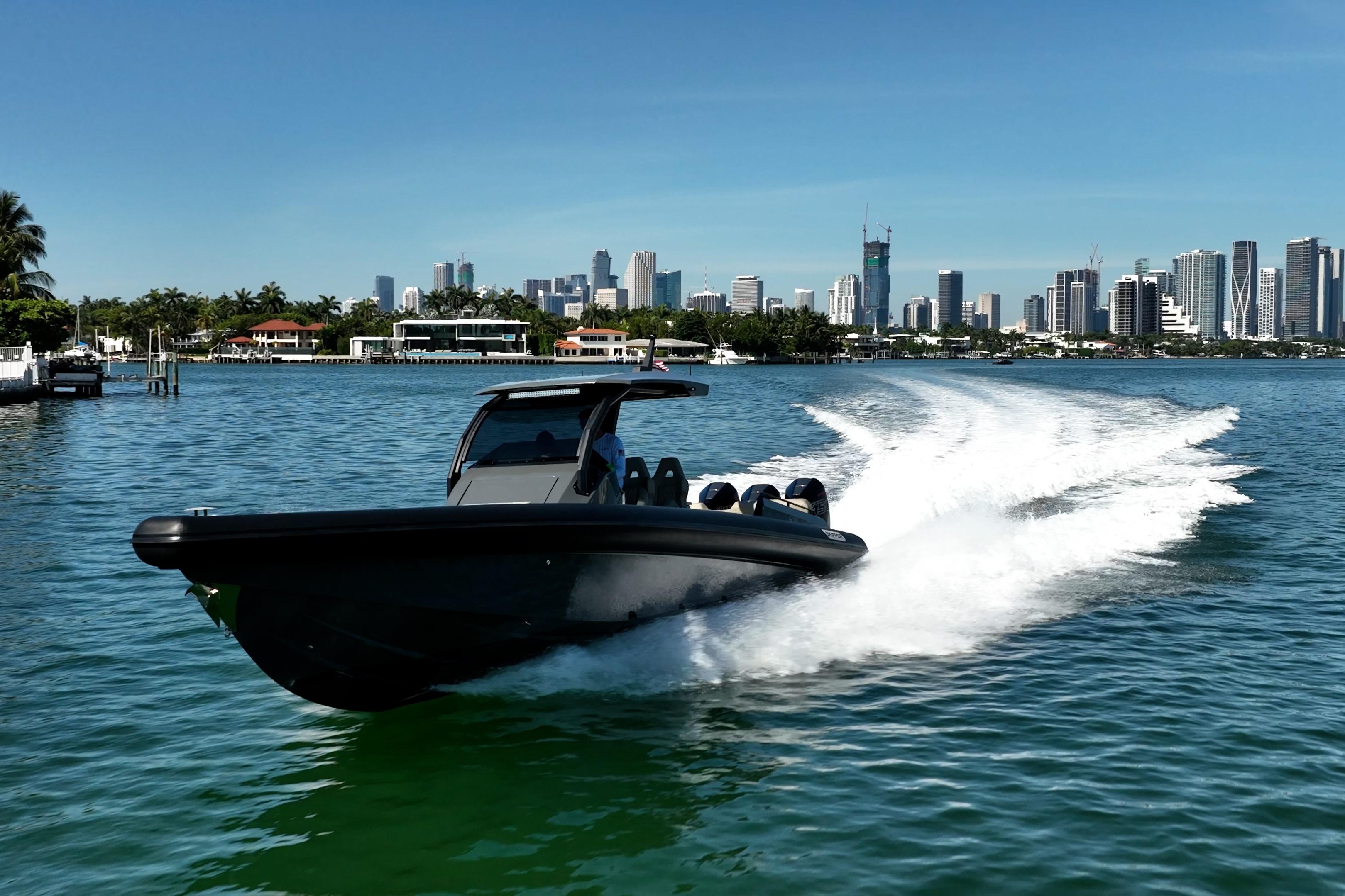 2023 Skipper-BSK 38NC speedboat cruising near city skyline on sunny day.