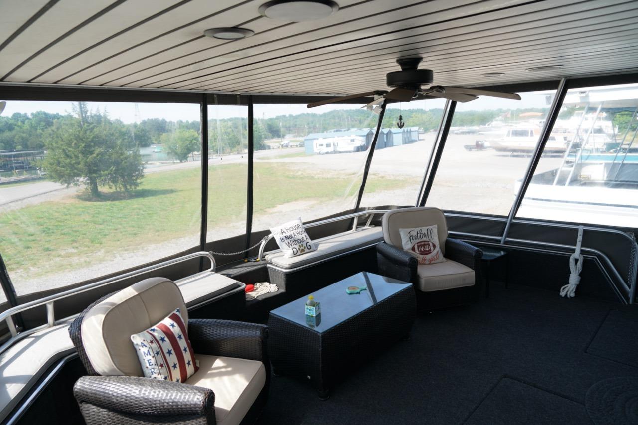 Spacious interior of 2000 Stardust Cruisers houseboat with comfortable seating and scenic views.