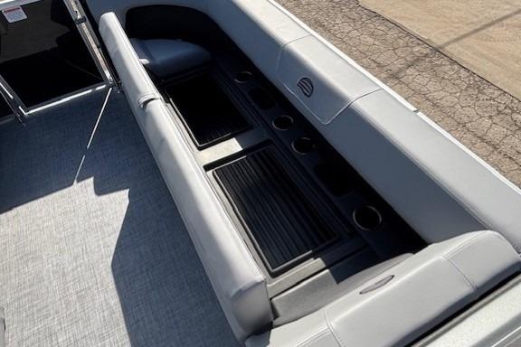 2026 Sun Tracker Party Barge 18 DLX interior with gray seating and cup holders.