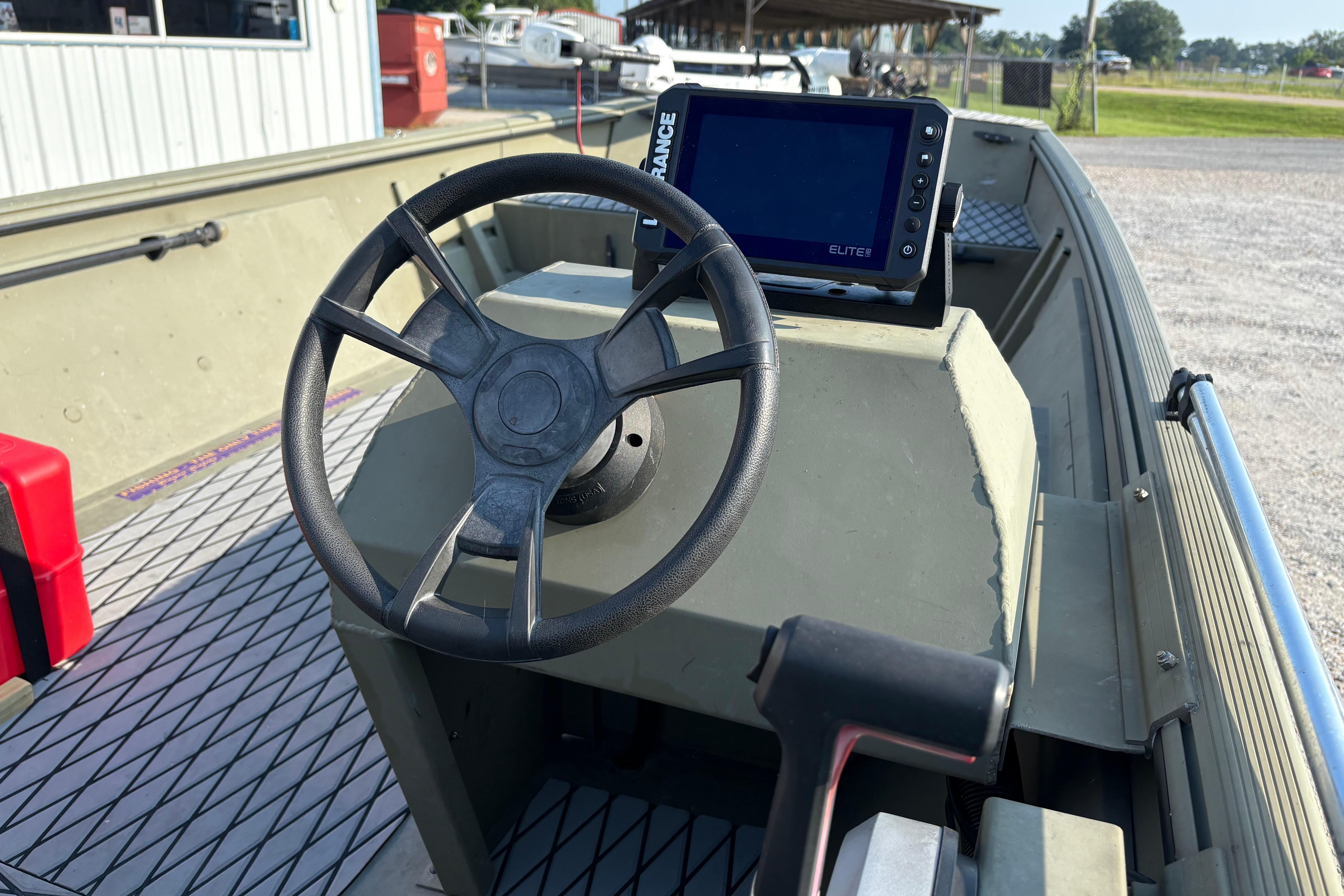 Steering console of a 2019 Lowe Roughneck 1860SC boat with navigation display.
