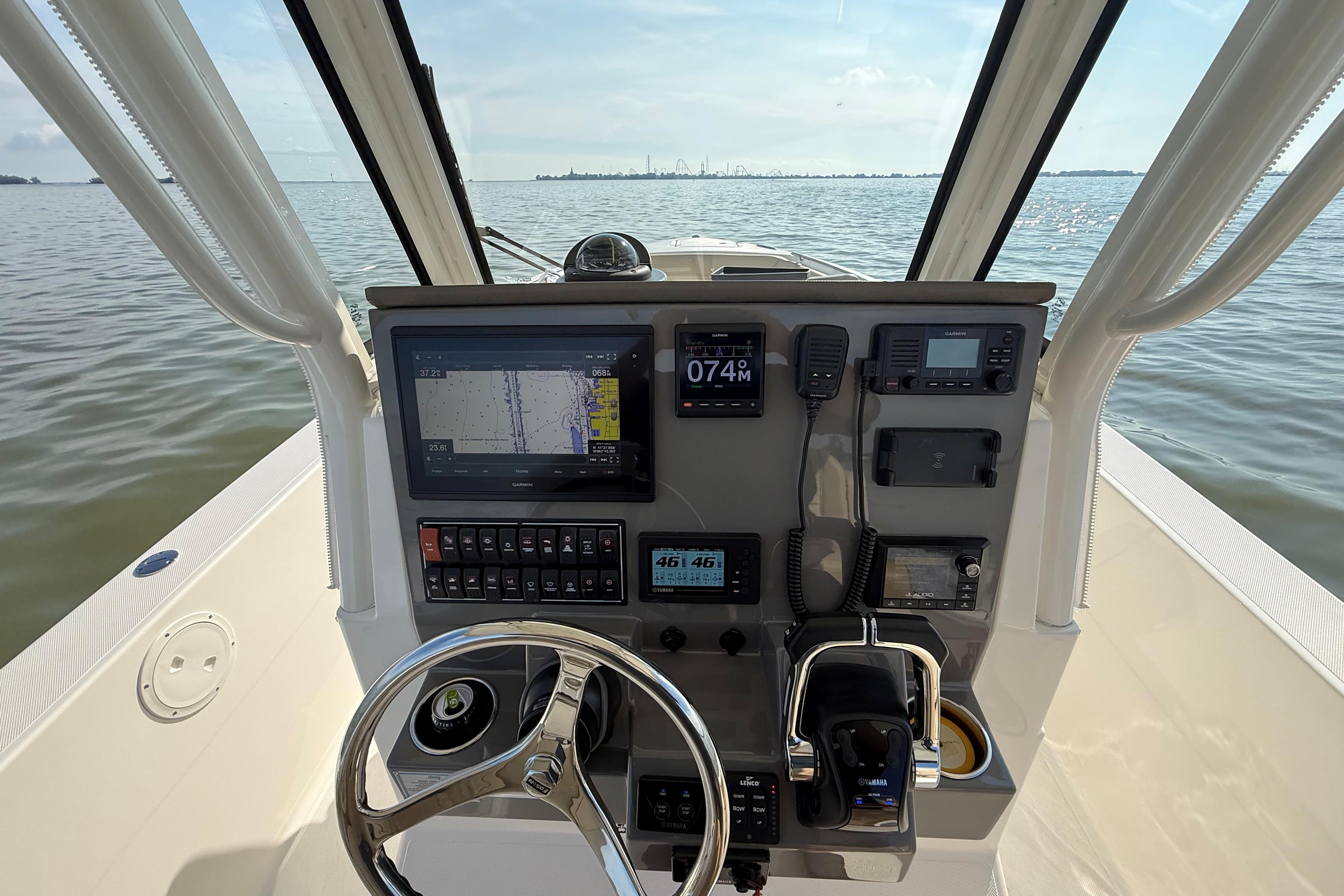 2021 Pursuit S 268 Sport boat dashboard with navigation and control systems on open water.