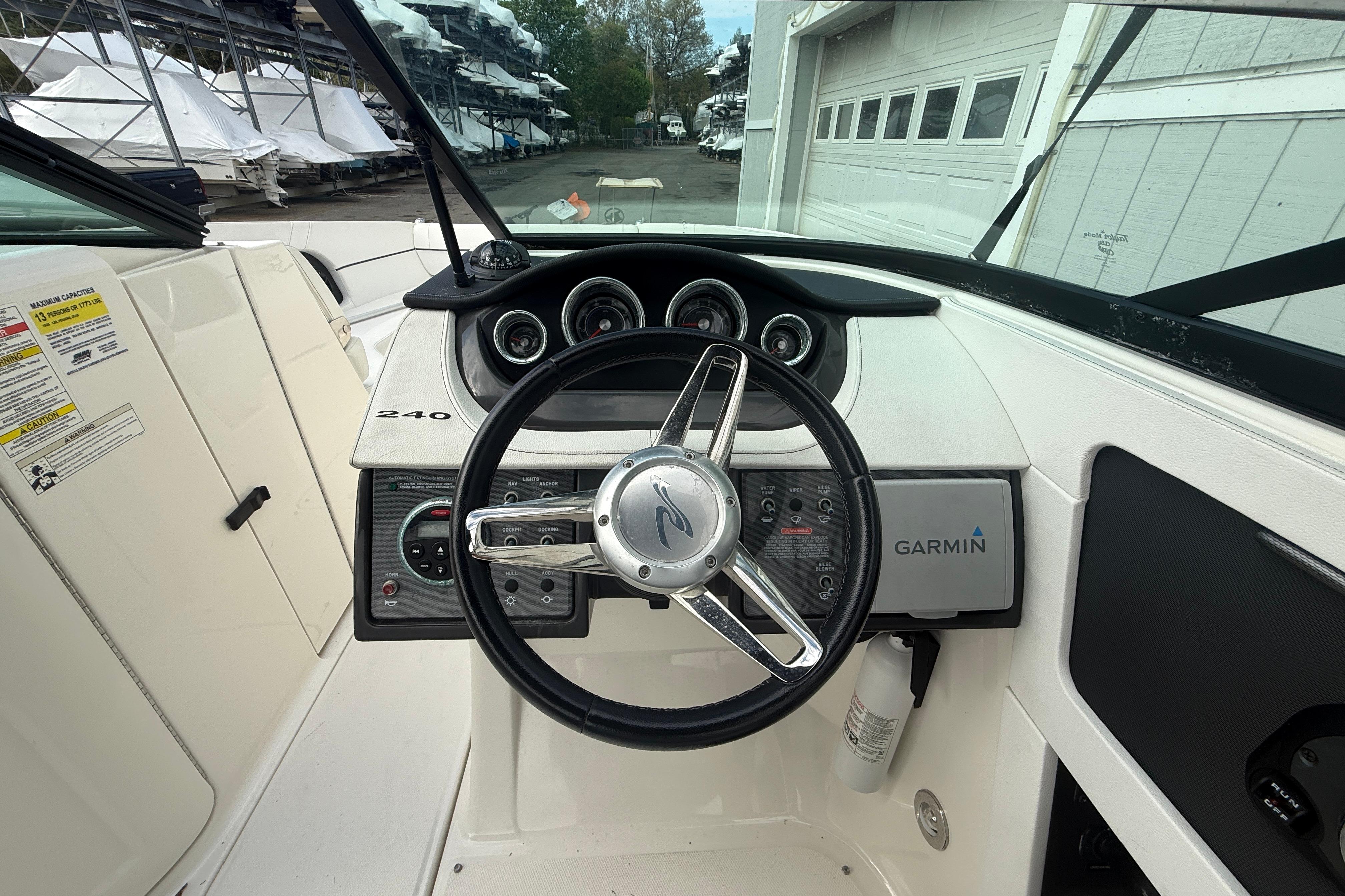 2015 Sea Ray 240 Sundeck helm with Garmin navigation and sleek dashboard design.