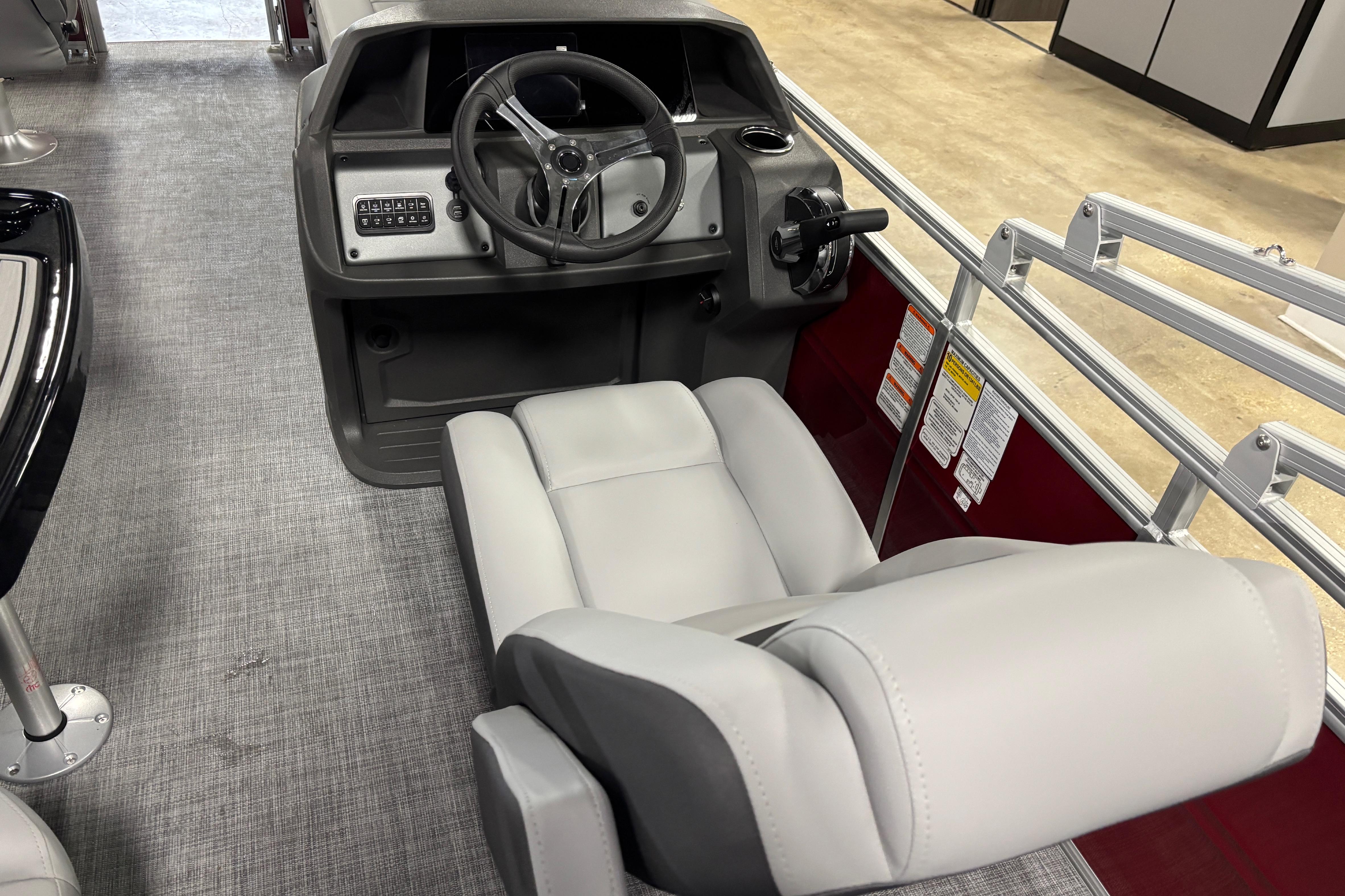 Interior view of 2026 Sun Tracker SportFish 20 DLX boat with steering console and seating.