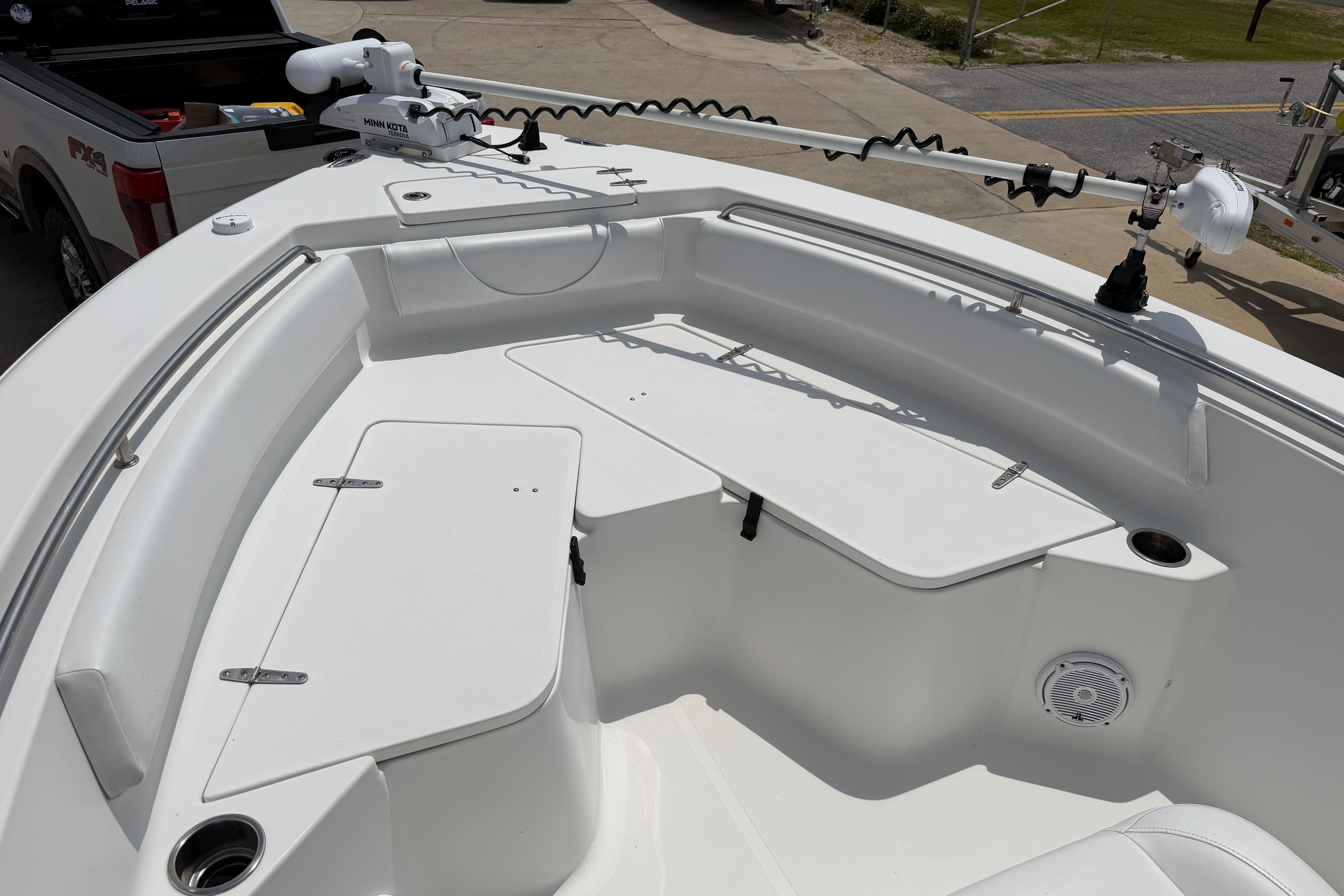 2015 Sea Hunt Triton 225 boat interior with storage compartments and trolling motor.