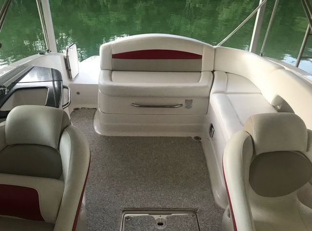 Interior of a Chaparral Sunesta 244 boat with comfortable seating and a view of the water.