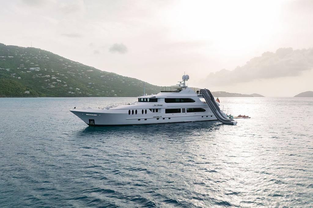 Luxury yacht Ares Custom Marine 141, 2012, with slide, anchored in scenic waters.