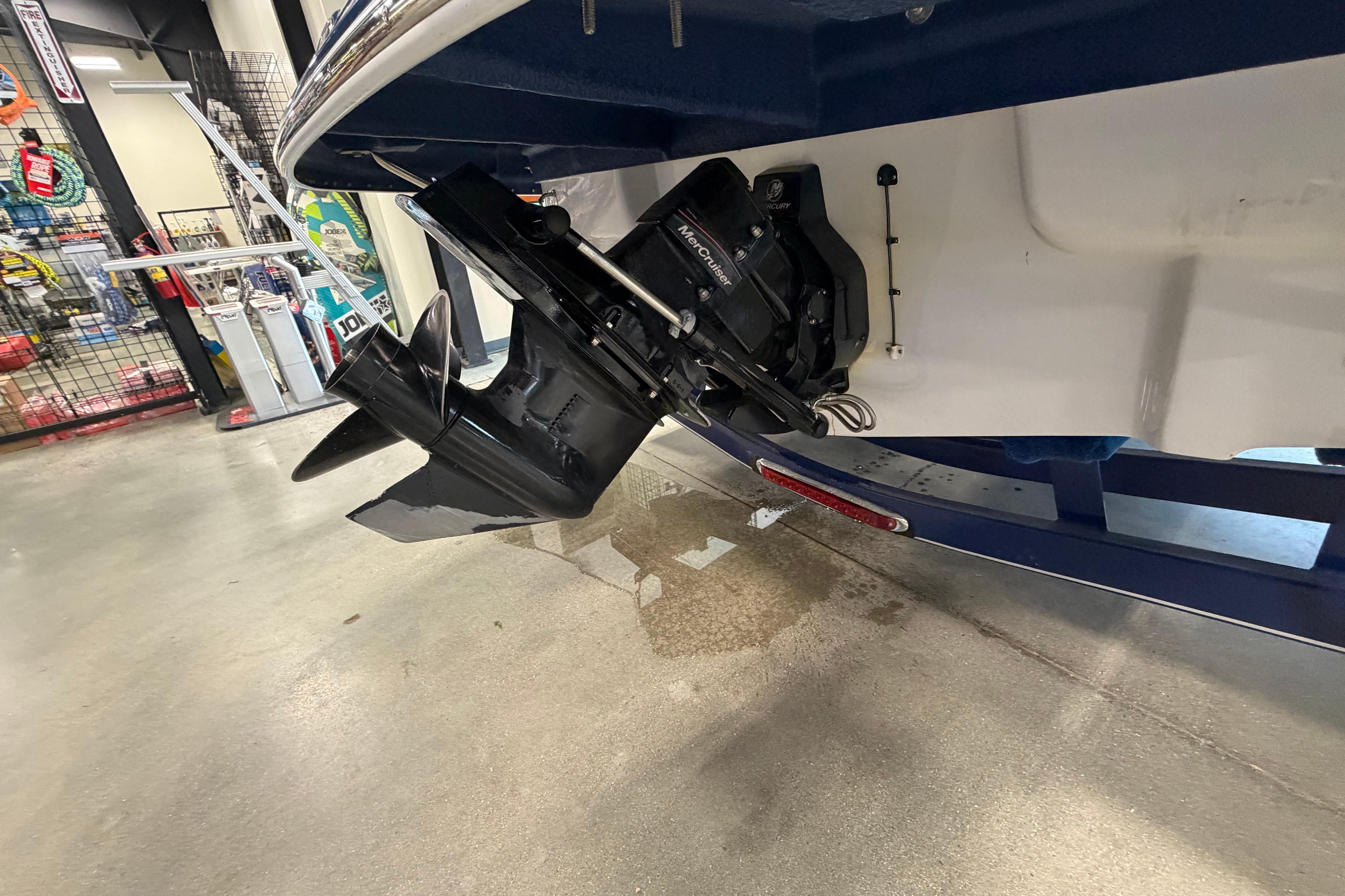 2008 Crownline 220 LS boat with MerCruiser outdrive in a showroom.