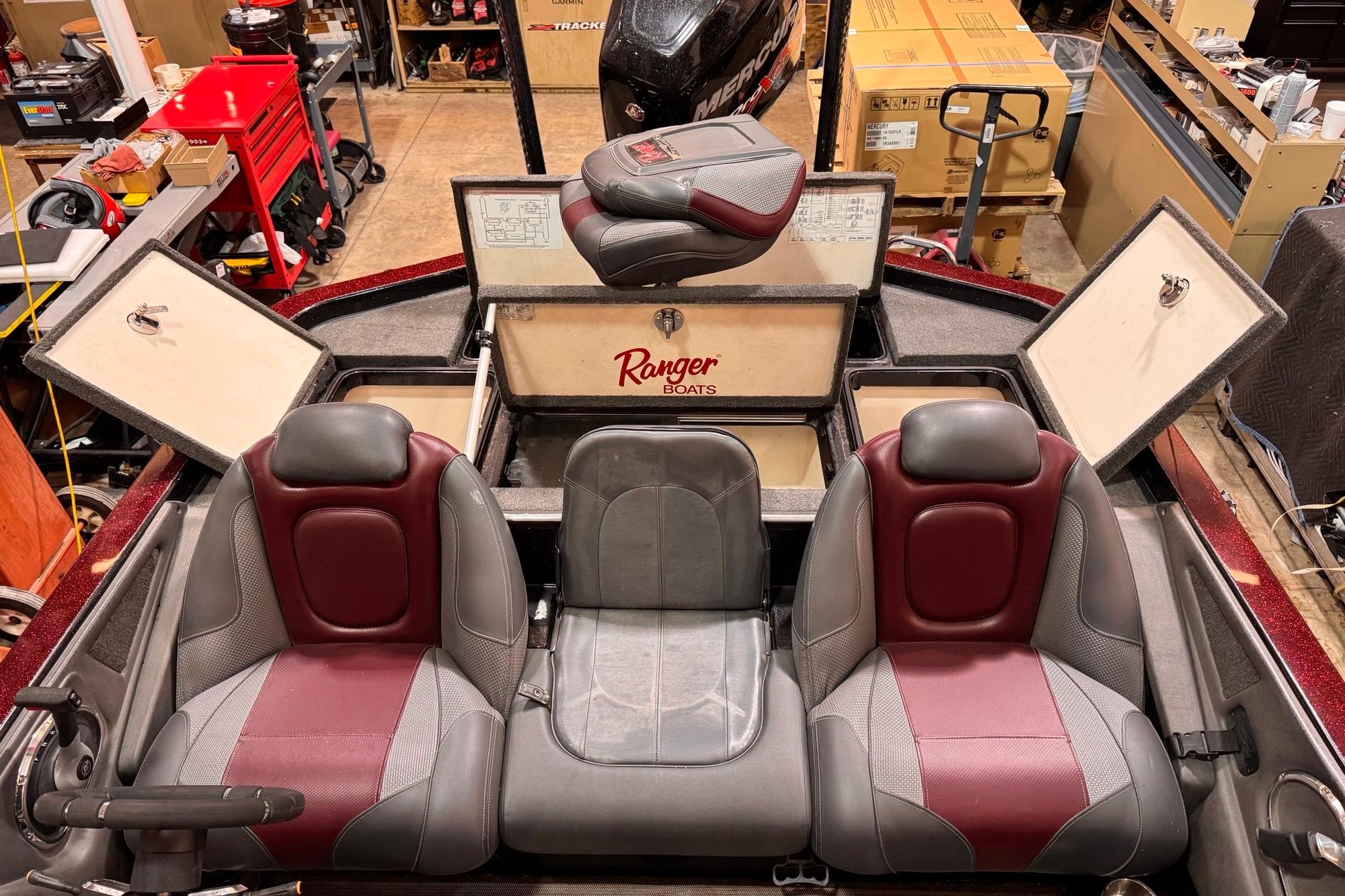 2017 Ranger Z520 Comanche boat interior with red and gray seats in a workshop setting.