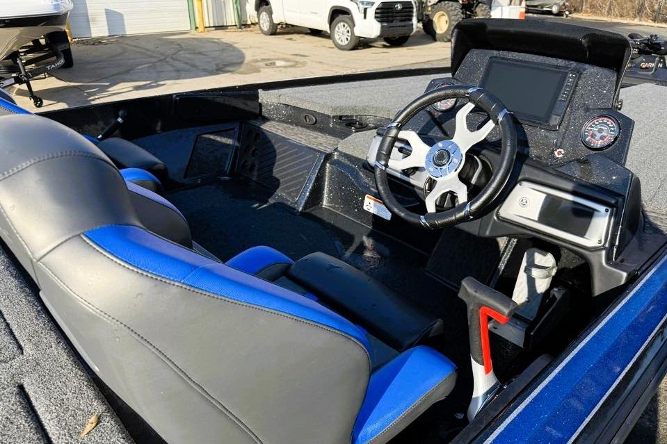 2026 Nitro Z20 XL Pro boat interior with steering wheel and blue-accented seats.