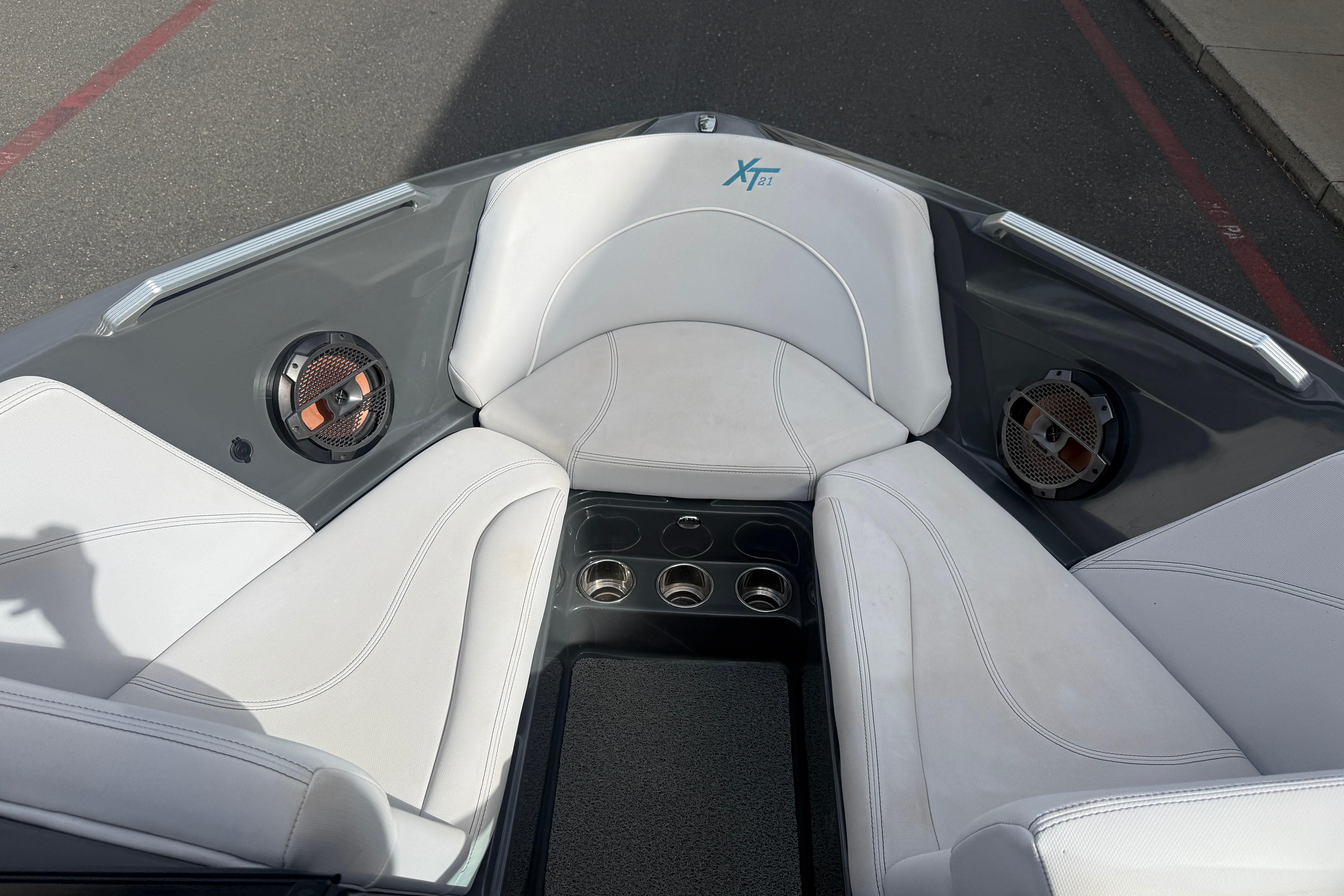 2018 MasterCraft XT21 boat interior with white seating and built-in speakers.