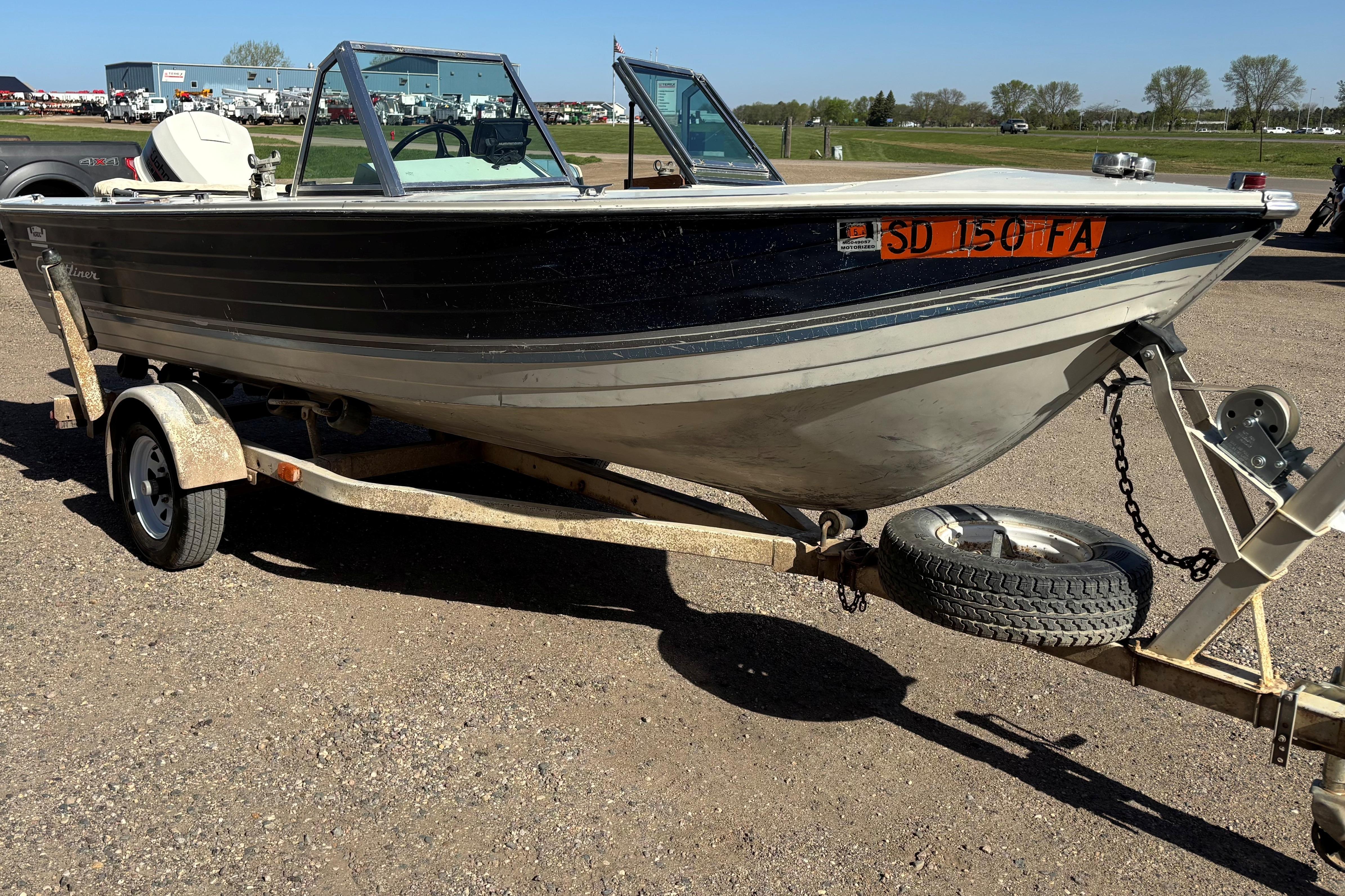 1983 Crestliner 16 boat on trailer, parked outdoors on a sunny day.