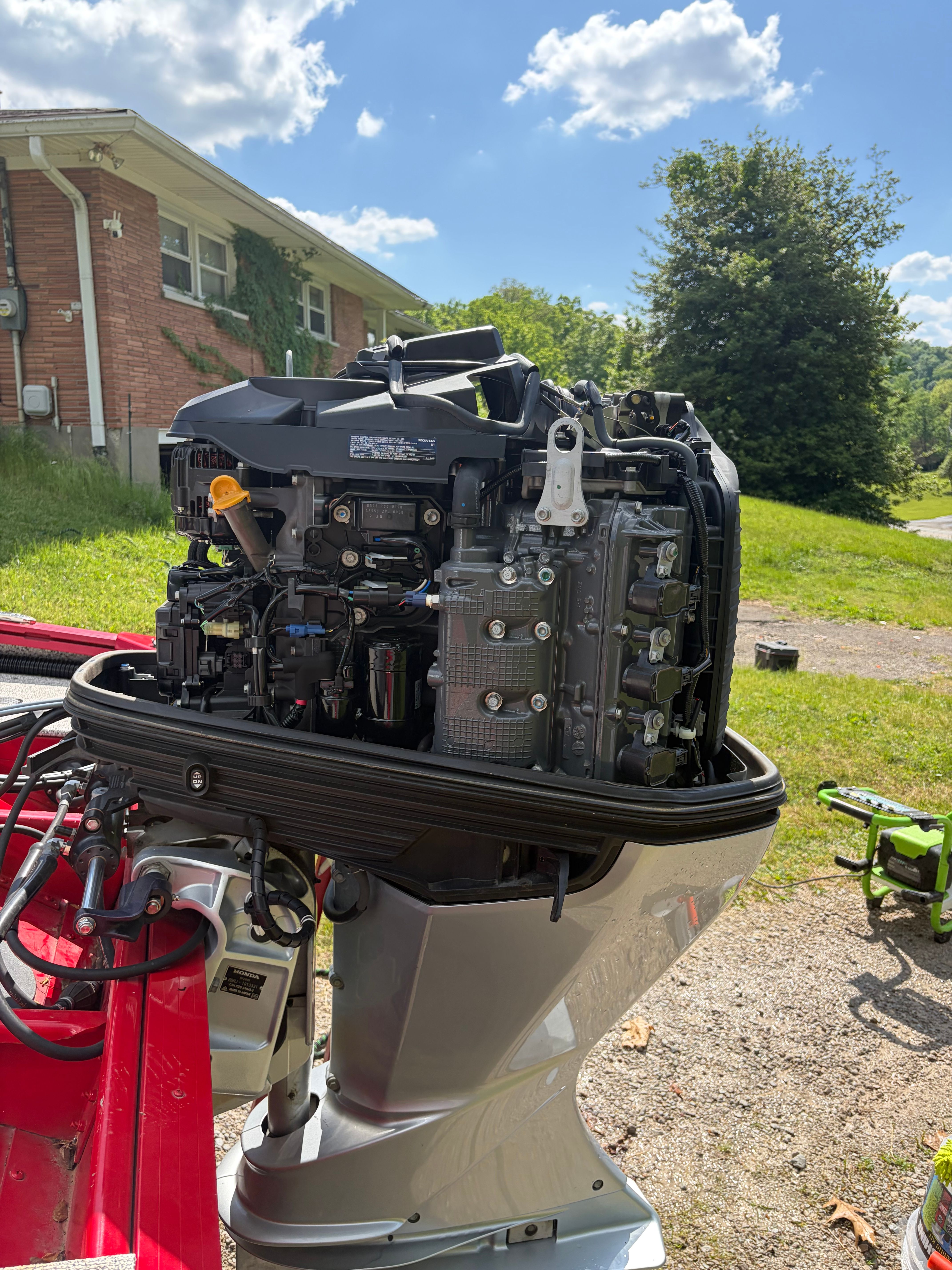 Outboard motor of a 2024 Polar Kraft Outlander 2010 outdoors.