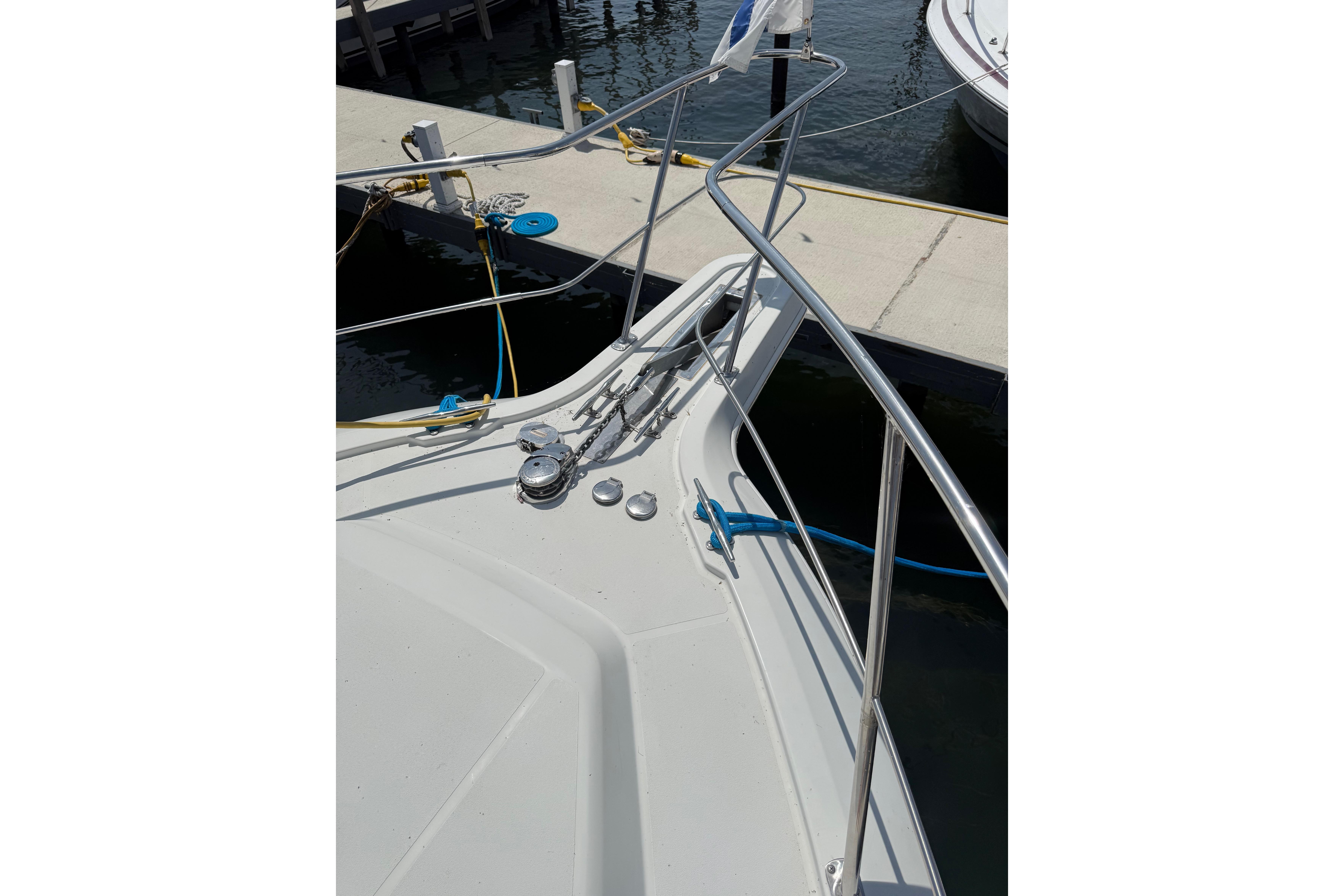 Bow view of 1996 Carver 400 Cockpit Motor Yacht docked at marina.