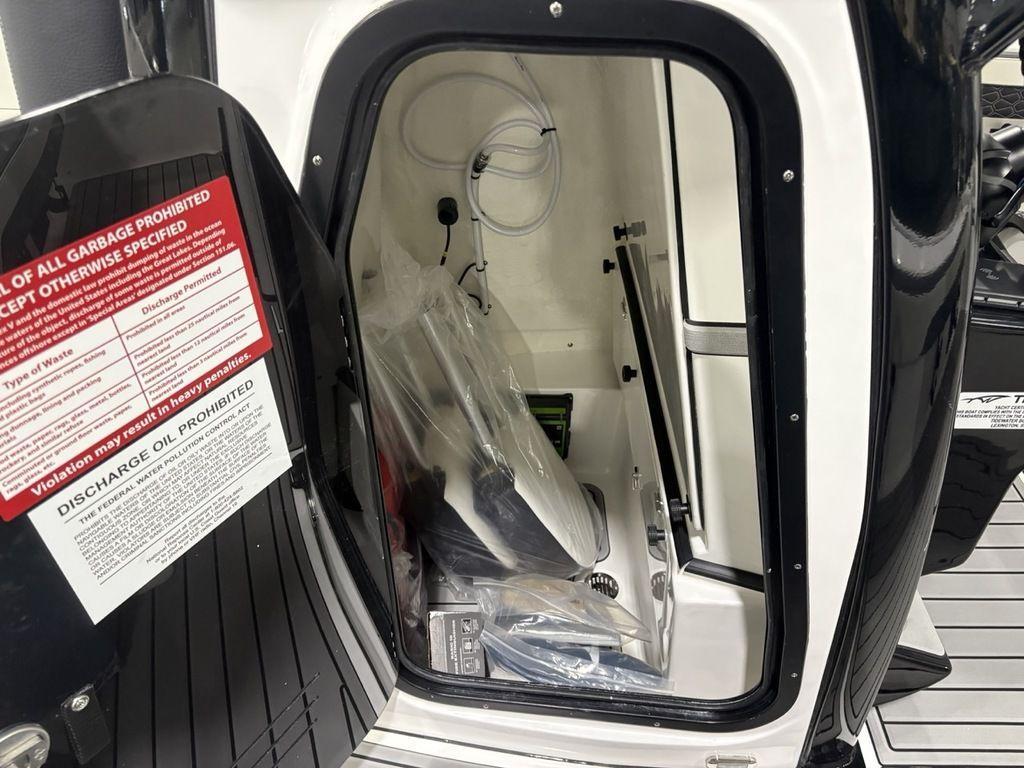2026 Tidewater 2700 CB storage compartment with safety and discharge instructions.