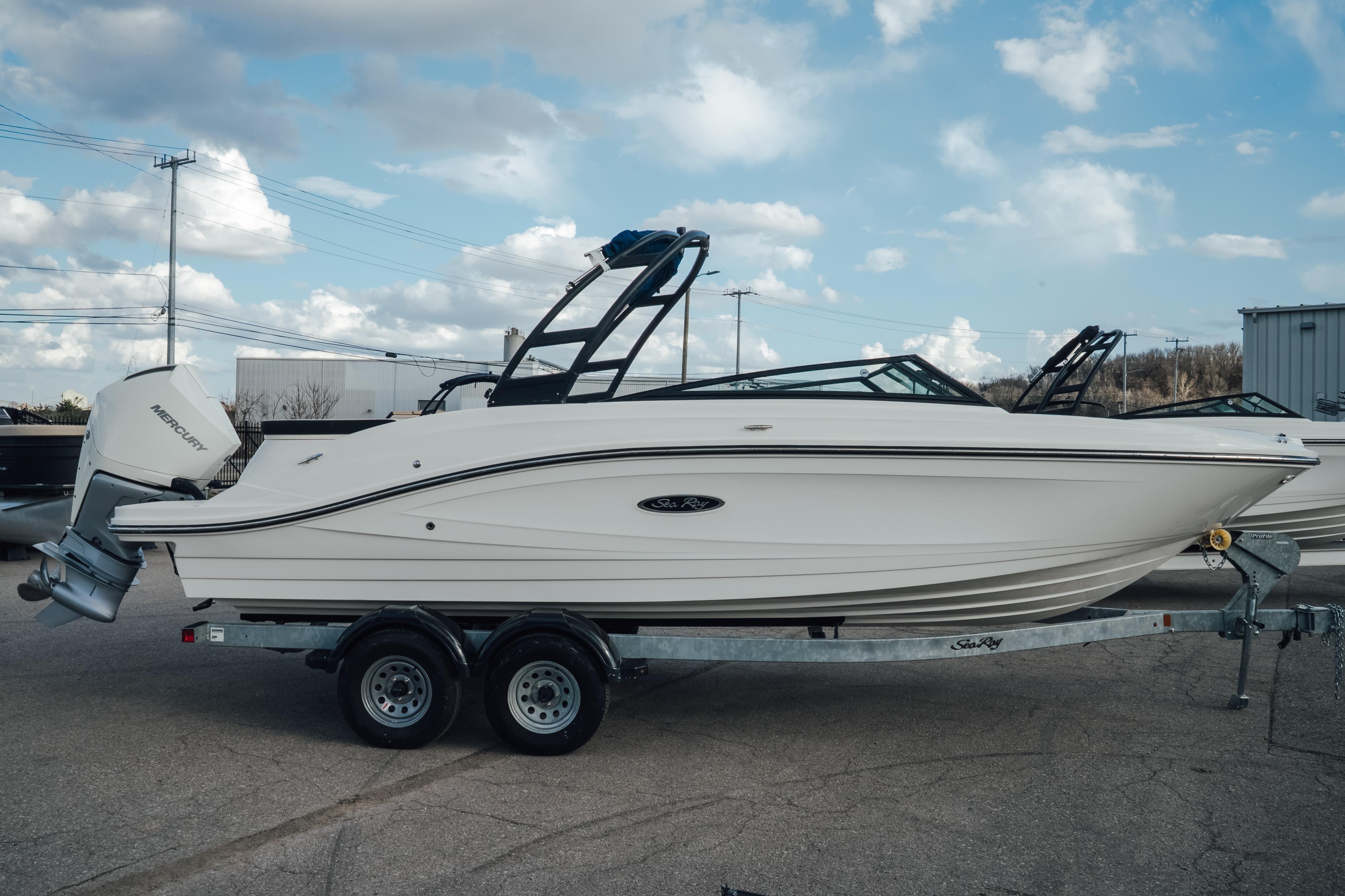 2023 Sea Ray SPX 230 Outboard boat on trailer under cloudy sky.