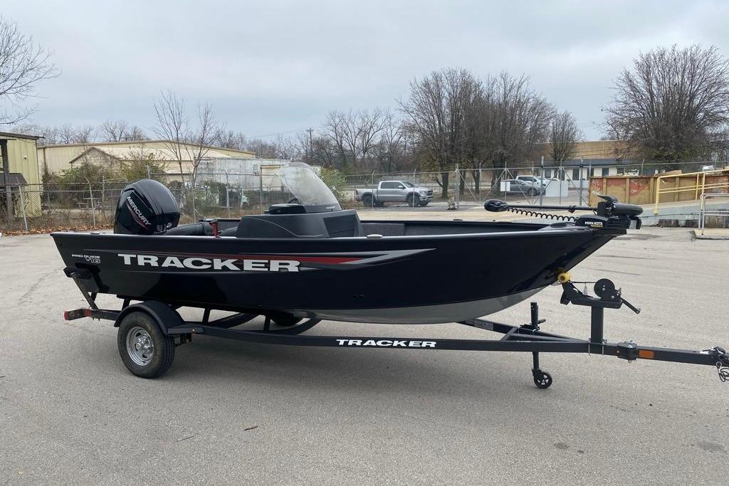 2026 Tracker Pro Guide V-16 SC boat on trailer in parking lot.