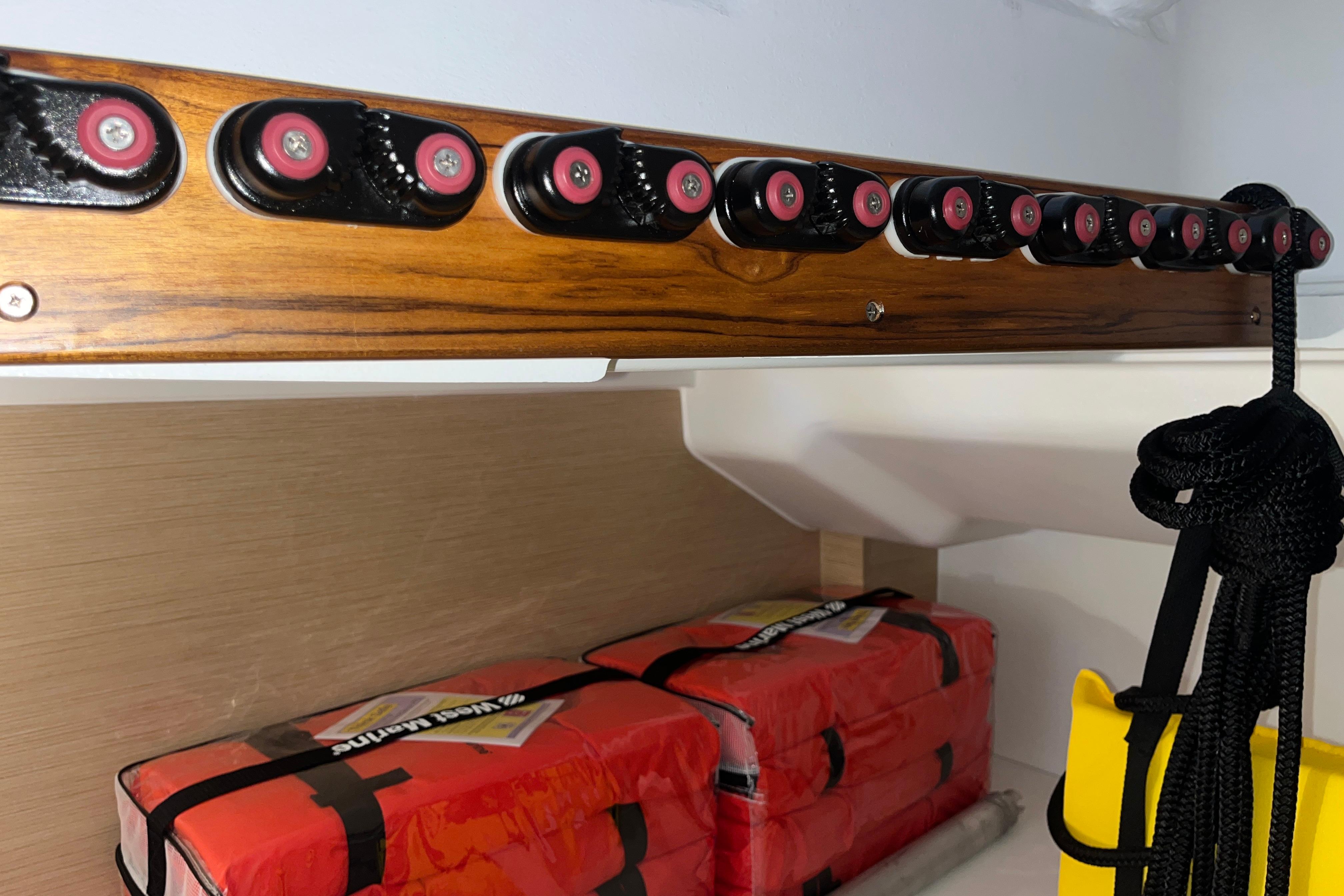 Storage area on a 2025 Hanse 360 yacht with safety equipment and ropes.