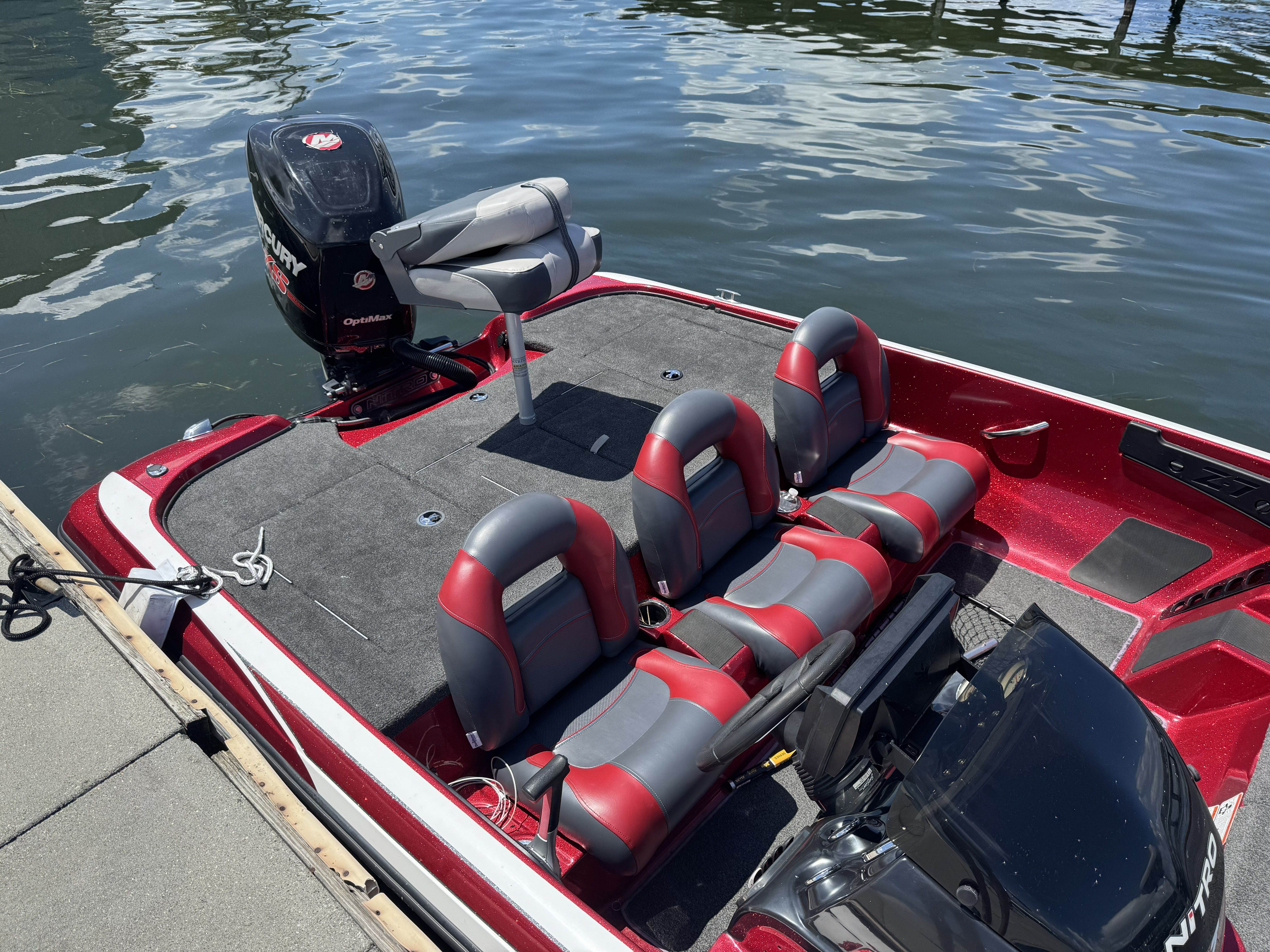 2014 Nitro Z71 boat with red and gray seats at the dock.