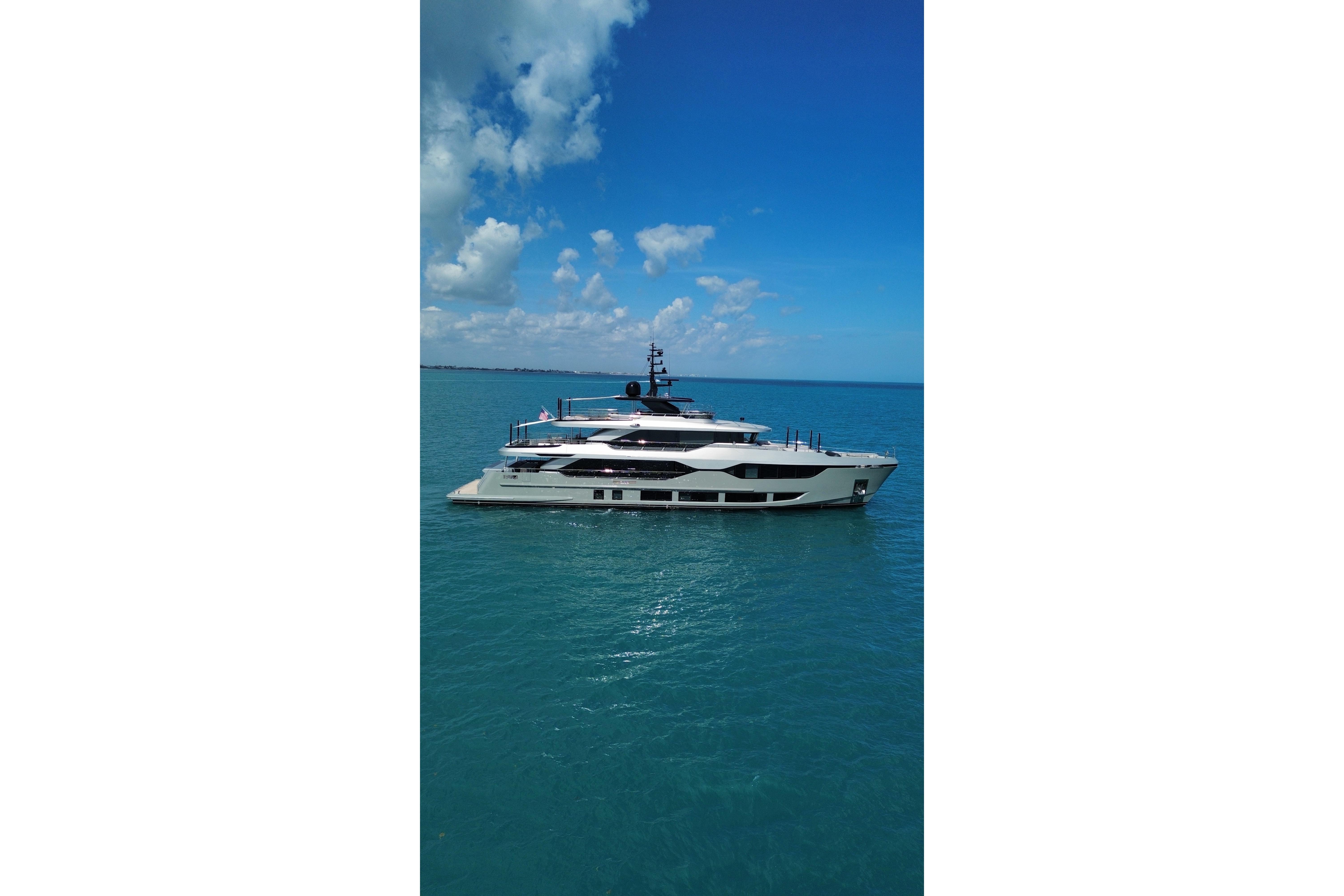 Luxurious 2025 Majesty 120 yacht cruising on clear blue ocean waters.