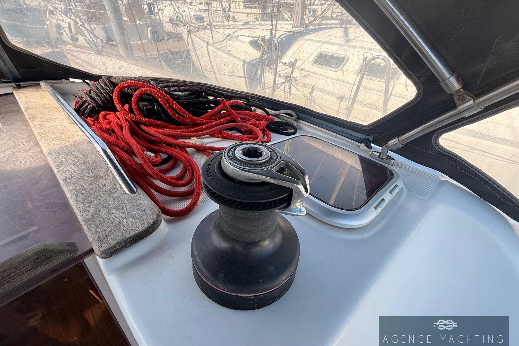 2009 Jeanneau Sun Odyssey 39i Performance yacht deck with winch and coiled ropes.
