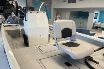2026 Crestliner 1860 Retriever CC boat interior with seating and console in showroom.