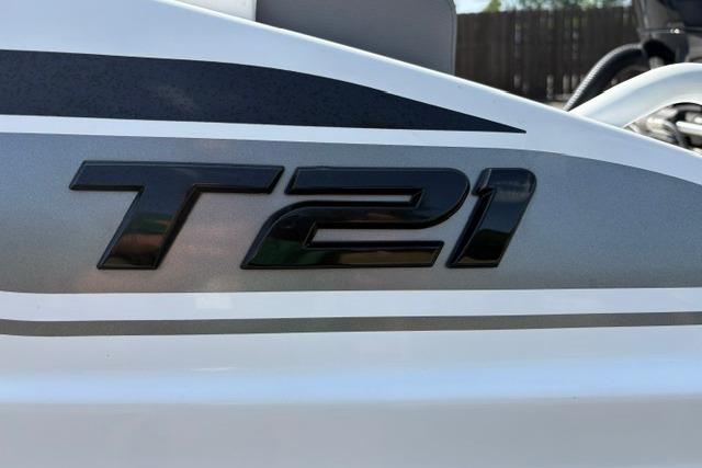 Close-up of 2024 Tahoe T21 model emblem on a sleek white surface.