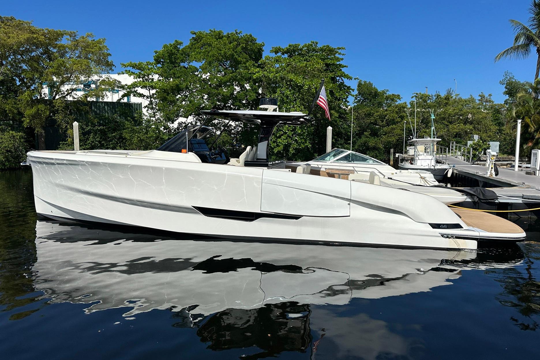 2025 Solaris Power 44 Open yacht docked, sleek design, reflecting on calm water.