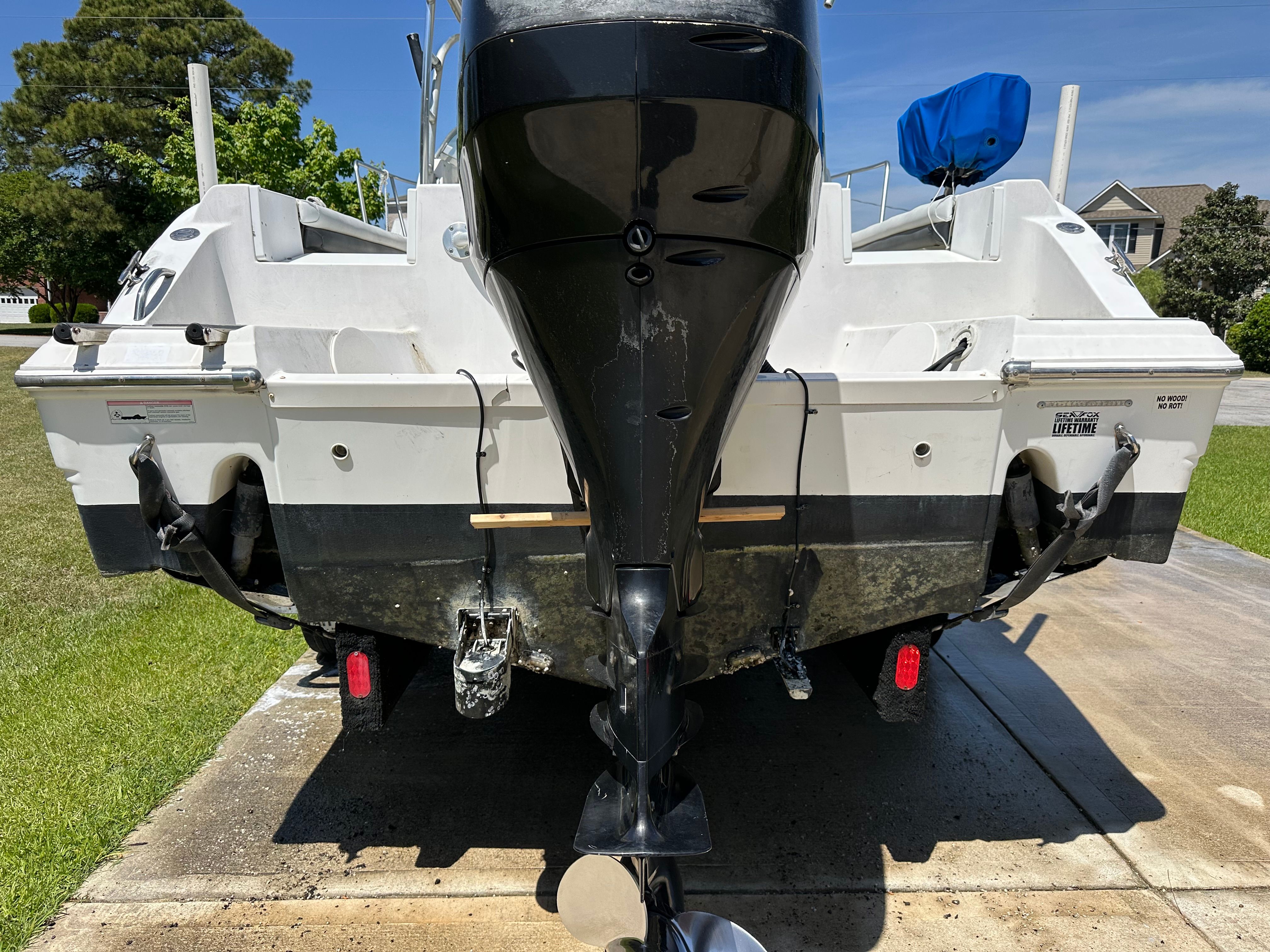 Rear view of a 2009 Sea Fox 256WA boat with outboard motor on a trailer.