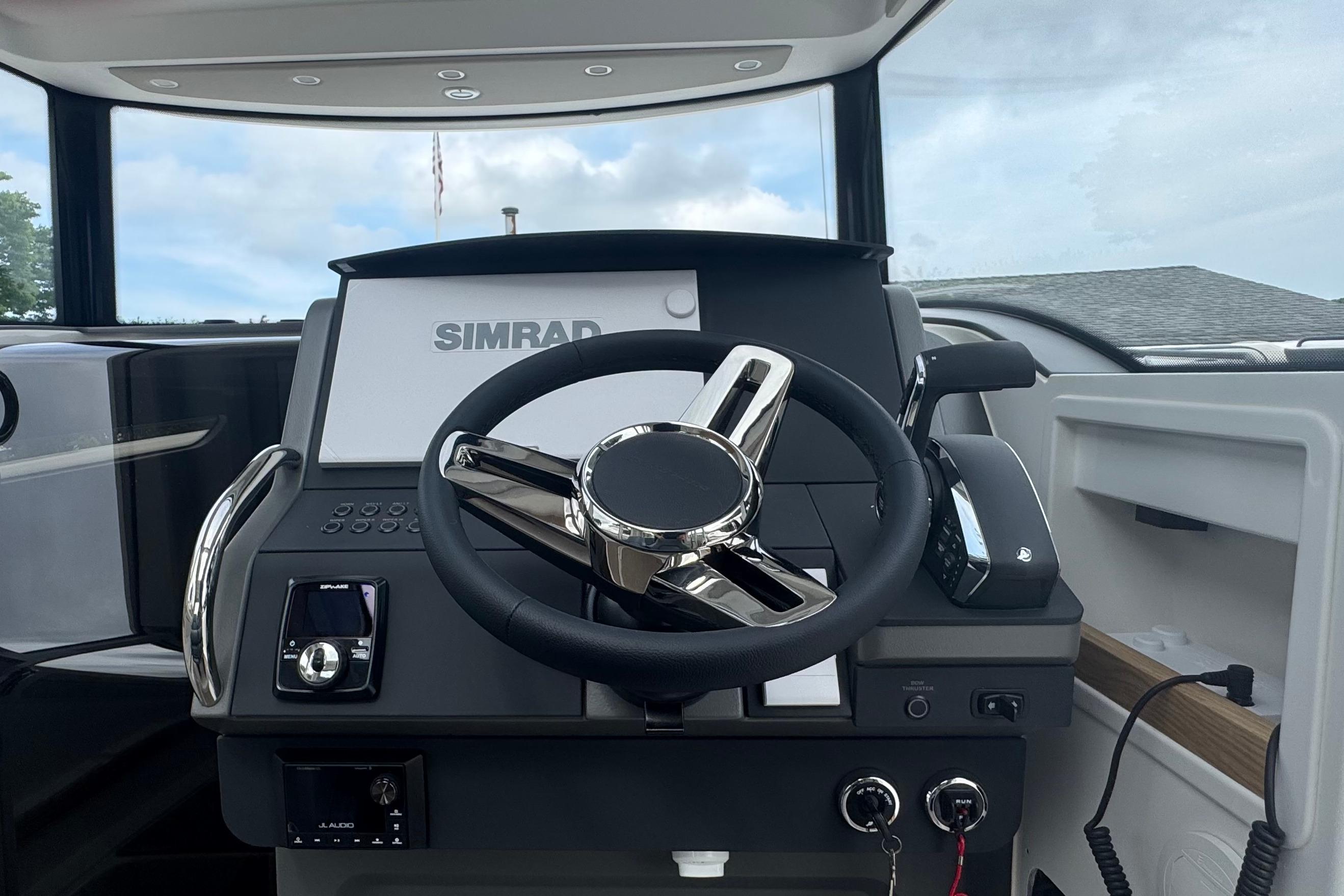 The image shows the helm of a 2026 Nimbus Commuter 9 with a modern Simrad display.