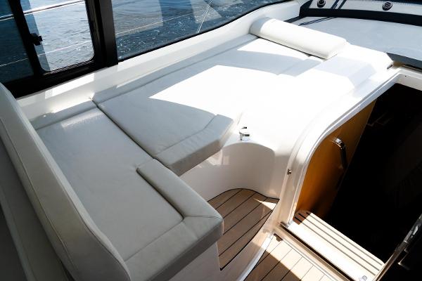 2022 Bavaria SR41 yacht interior with white seating and wooden flooring.