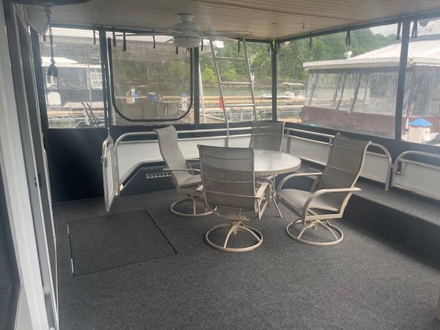 2009 Horizon 18 x 85 Houseboat interior with table and chairs on deck.