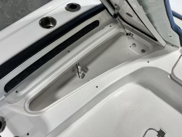 2025 Tidewater 2300 Carolina Bay boat storage compartment, open lid, sleek white interior design.