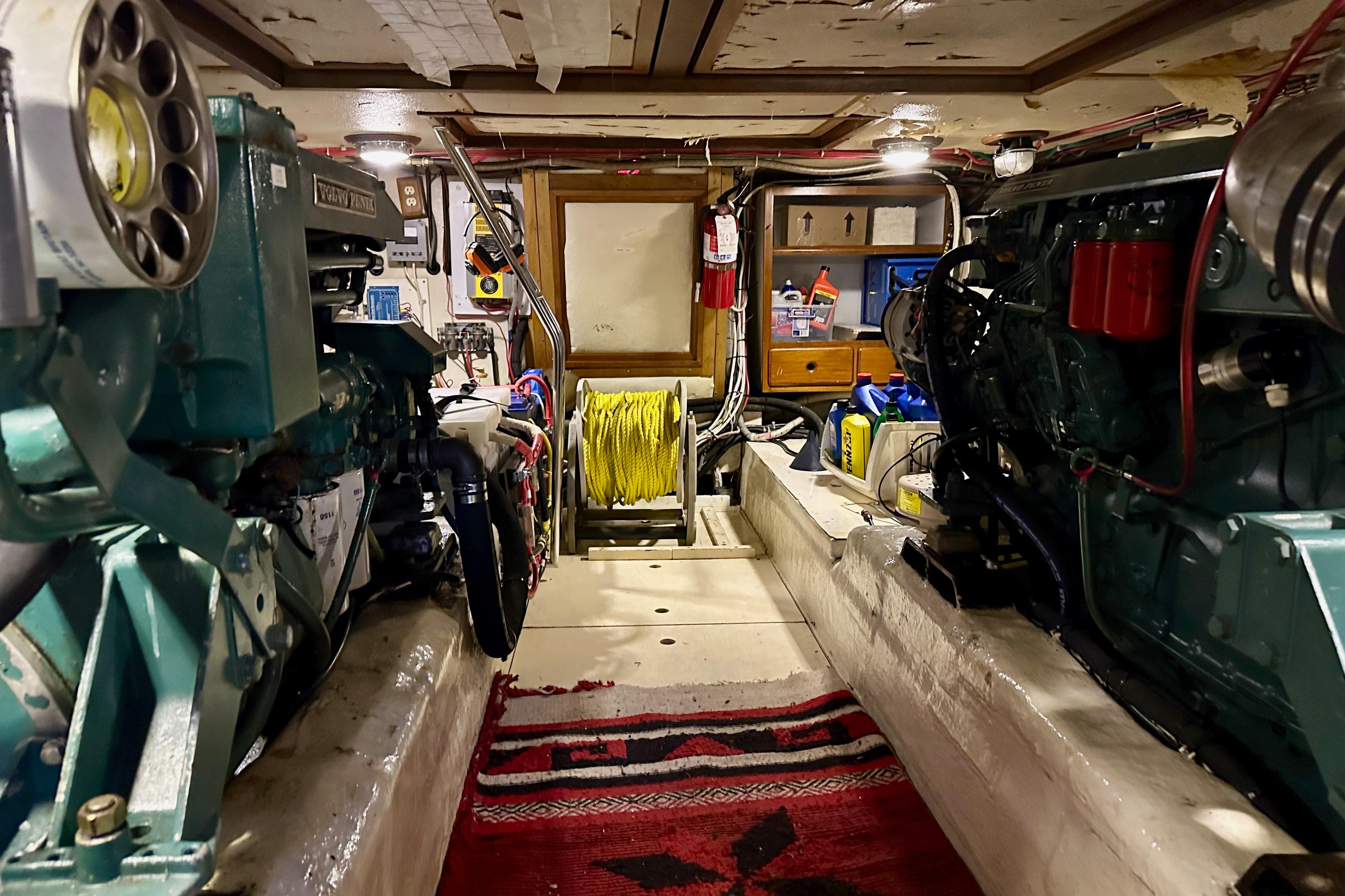 Engine room of a 1986 Kha Shing Spindrift 46 yacht, featuring dual engines and maintenance equipment.