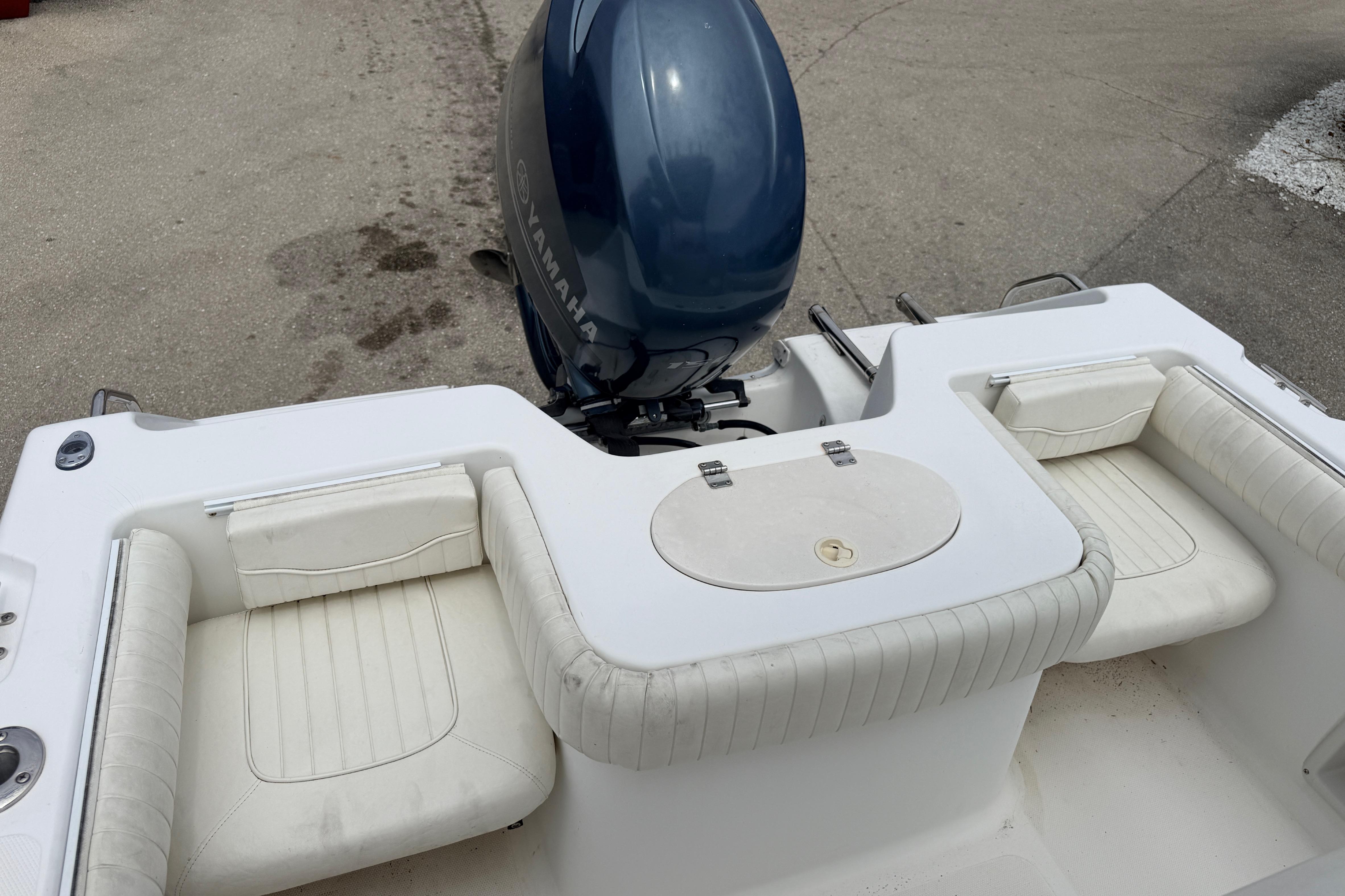 2007 Sea Hunt Triton 220 boat with Yamaha outboard motor and white seating.