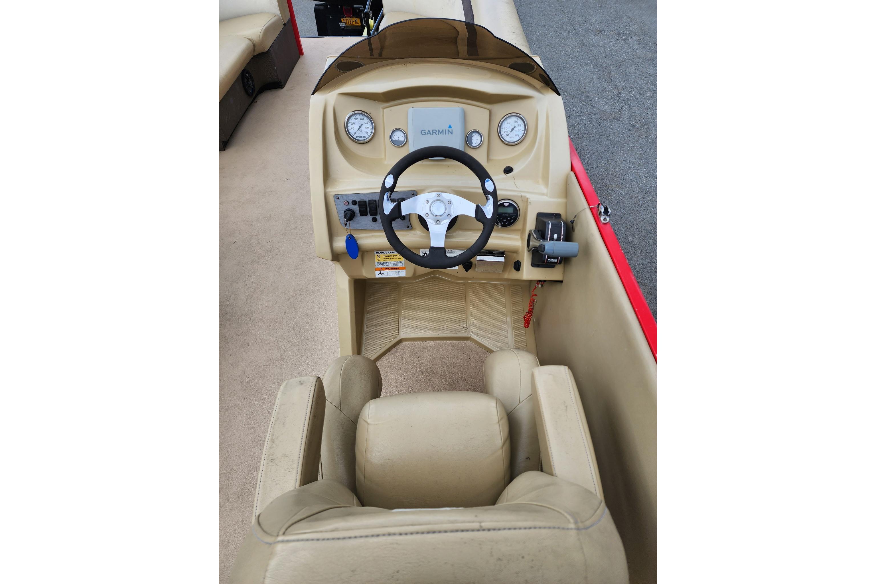 2017 Larson Escape RT 2400 Cruise Triple boat dashboard with steering wheel and controls.