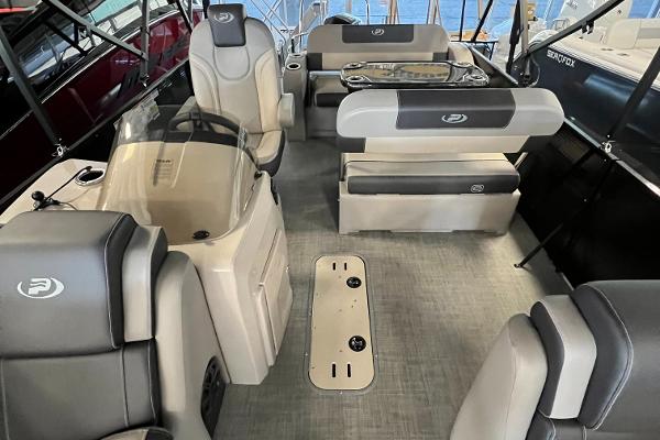 2024 Princecraft Quorum 23 RL pontoon boat interior with luxurious seating and helm.