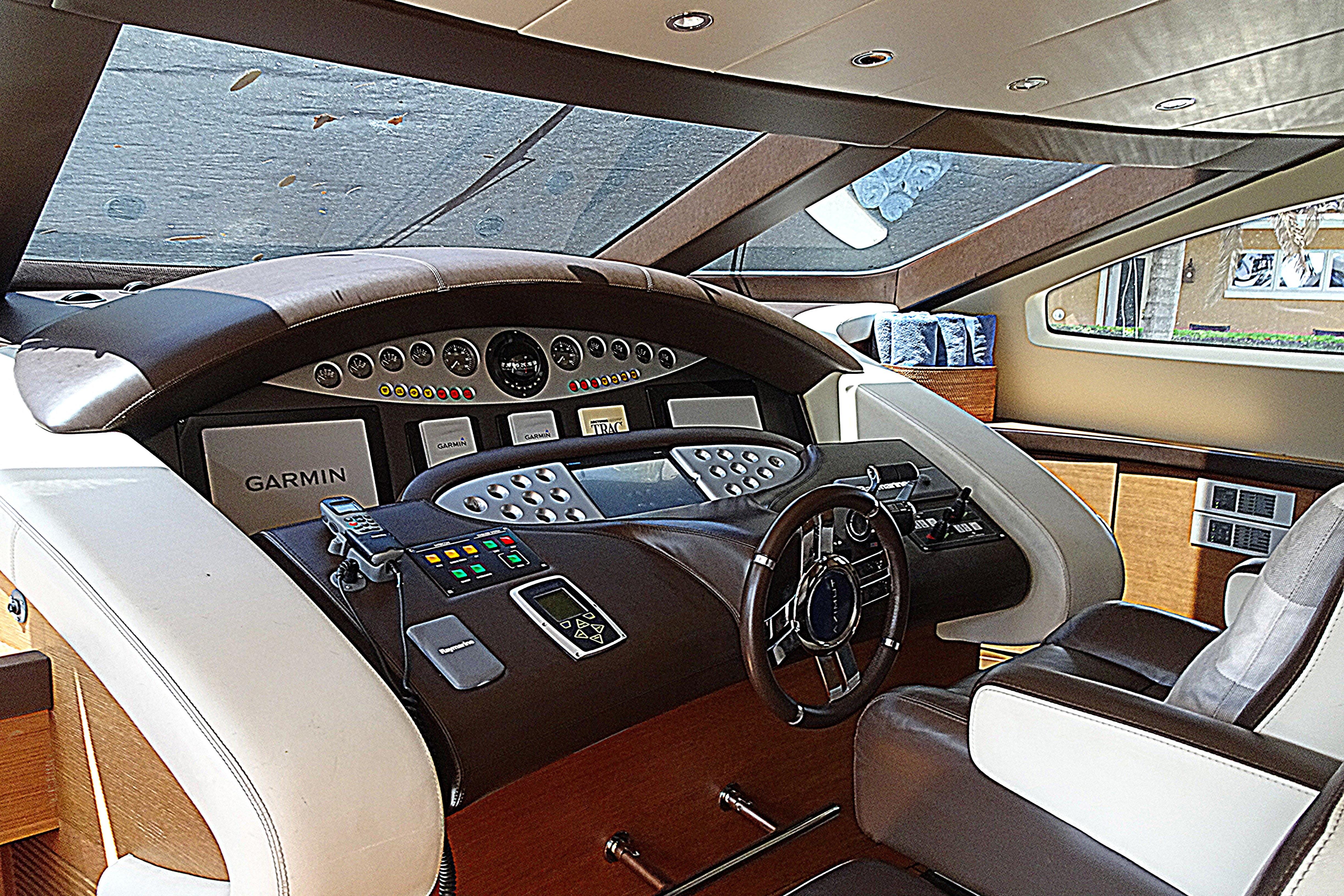 Luxurious helm of 2010 Azimut 100 Leonardo yacht with advanced navigation systems.