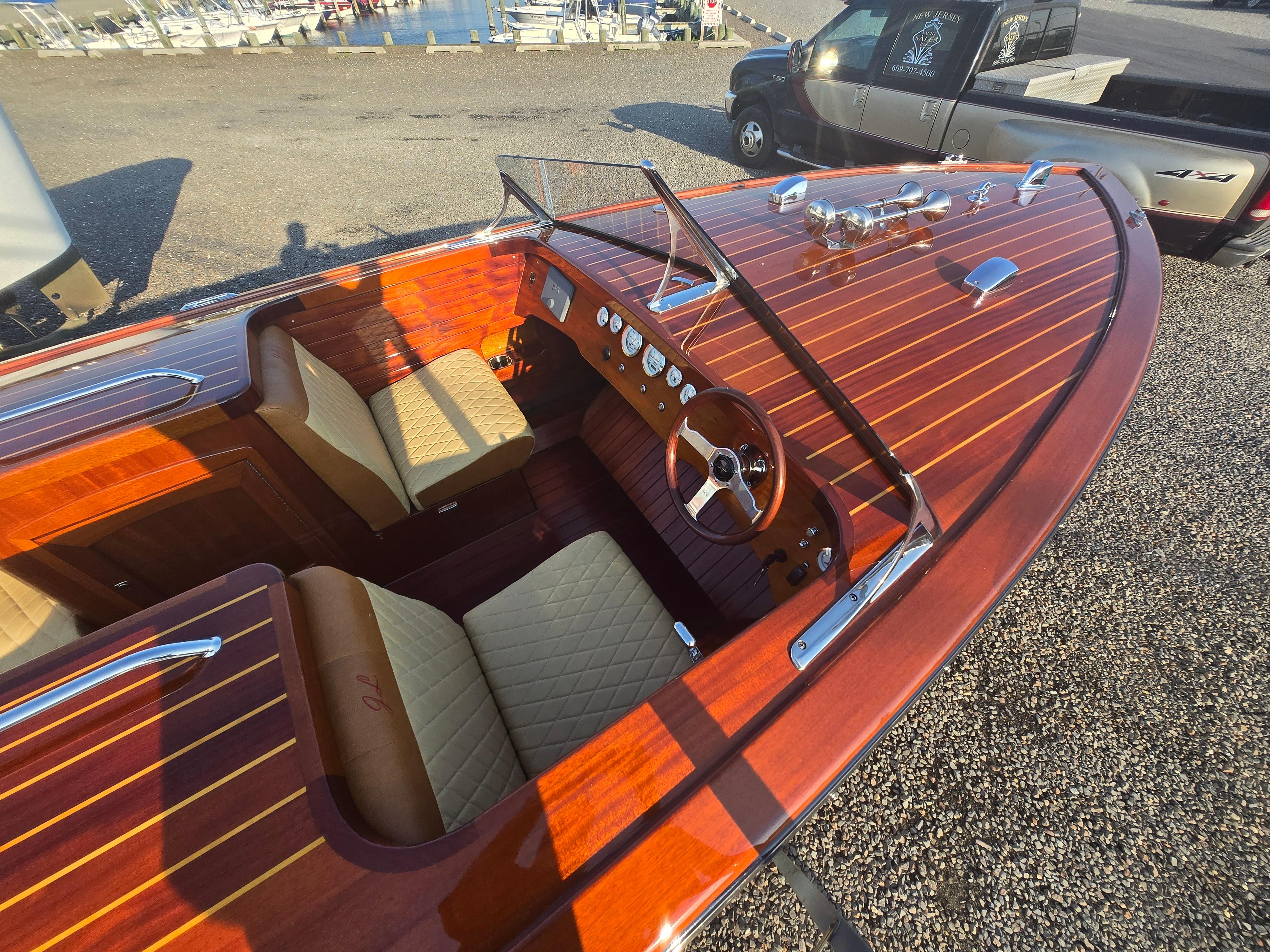 2018 Cherubini Classic 24 boat with polished wood finish and beige seating.