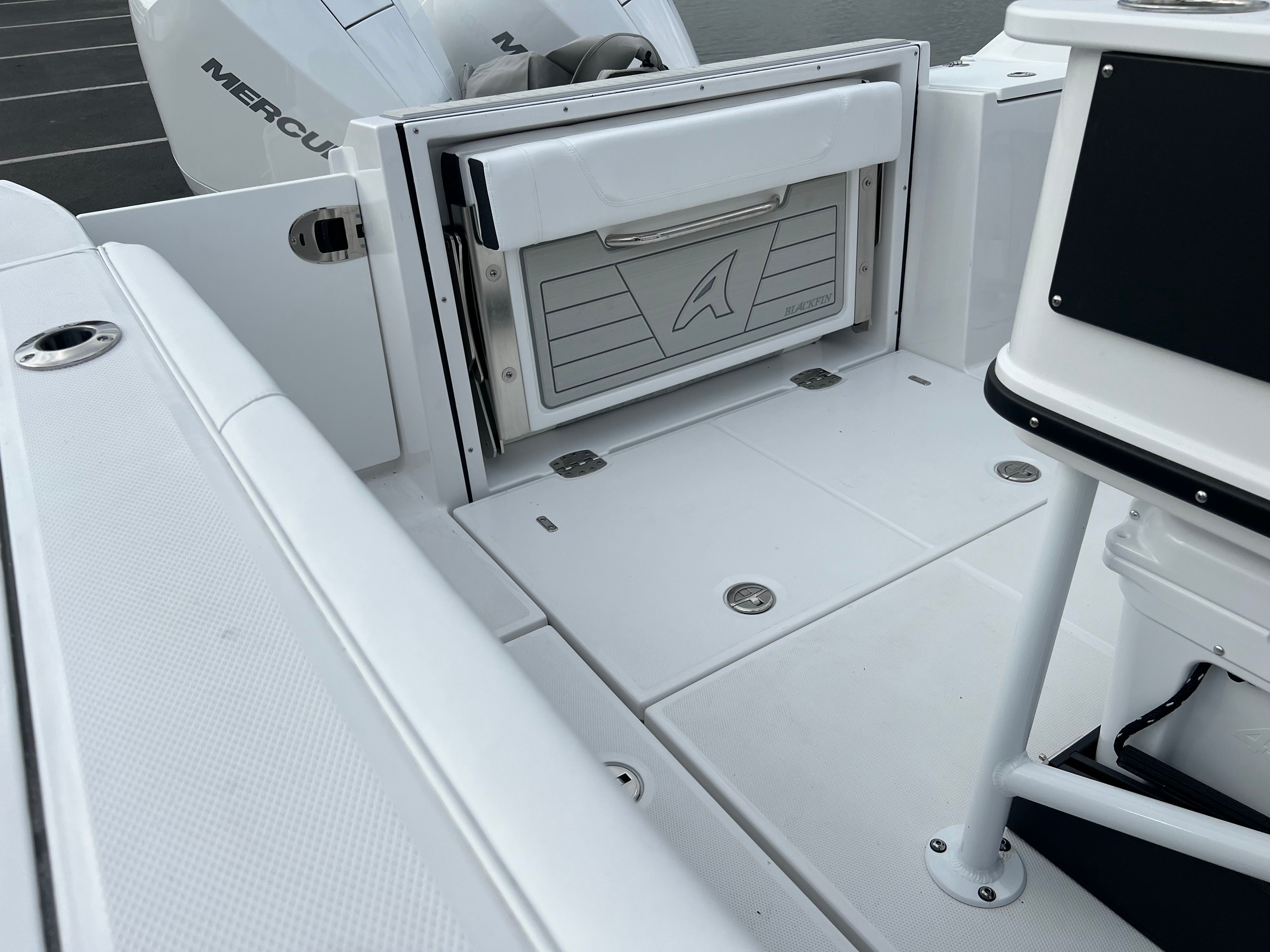 Interior of 2024 Blackfin 252 CC boat with storage compartment.