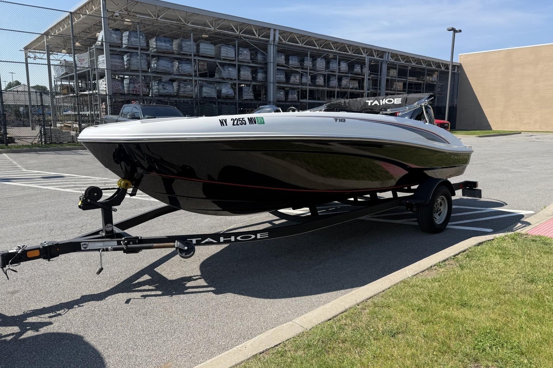 2024 Tahoe T18 boat on trailer in parking lot, sunny day.