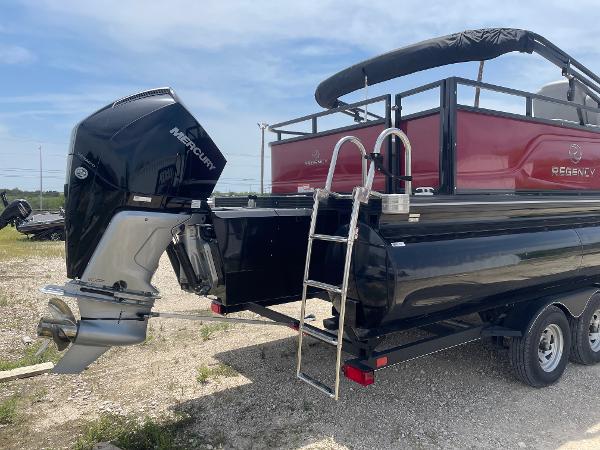 2023 Regency 250 DL3 pontoon boat with Mercury outboard motor and trailer.
