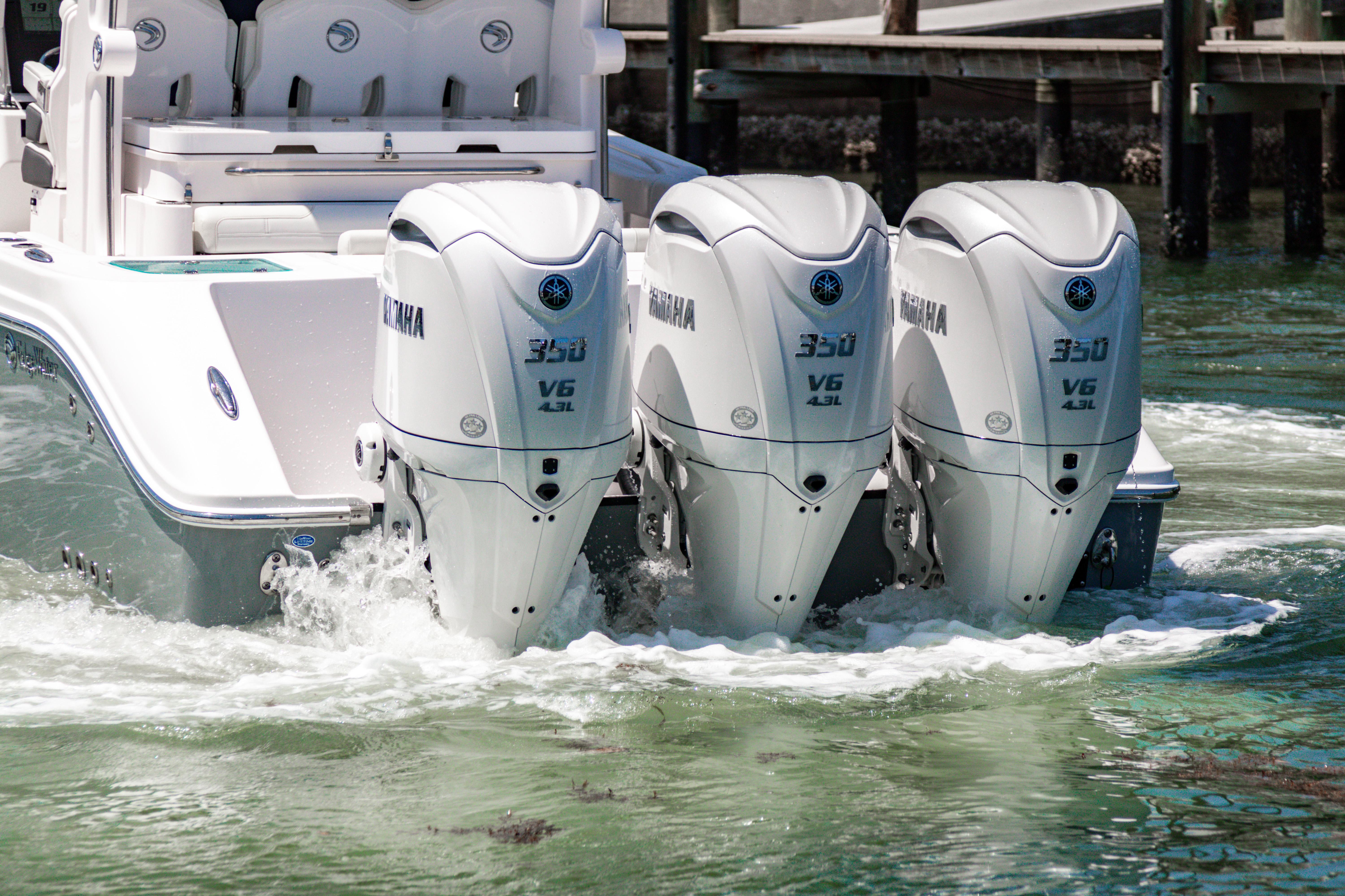2025 Edgewater 370CC boat with triple Yamaha 300 V6 engines in water.
