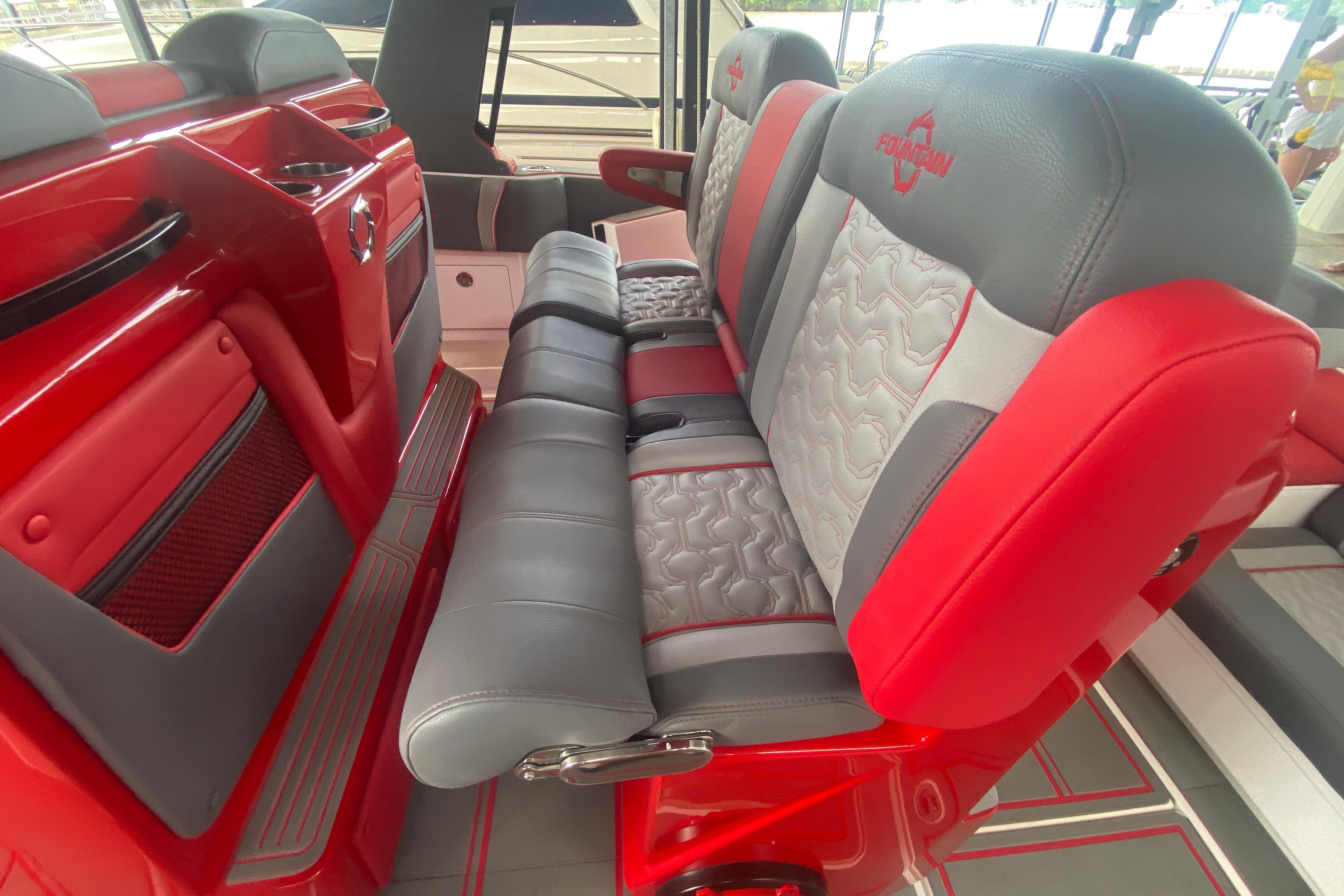 Red and gray seating in 2025 Fountain 38 SCX boat interior, showcasing modern design.