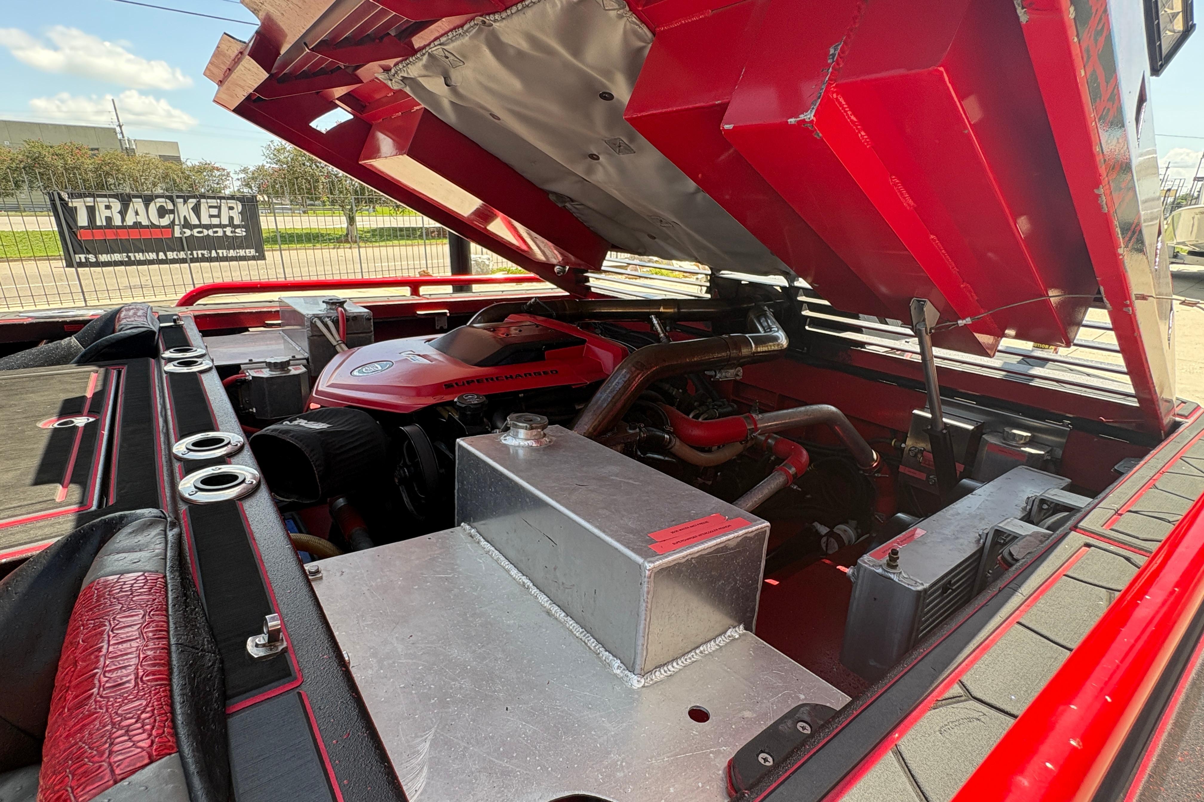 Open engine compartment of a 2018 Custom Swamp Shark 24' boat, showcasing mechanical components.