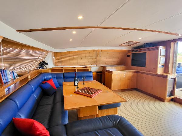 Luxurious interior of a 2009 Catana 65 yacht with modern furnishings and a cozy seating area.