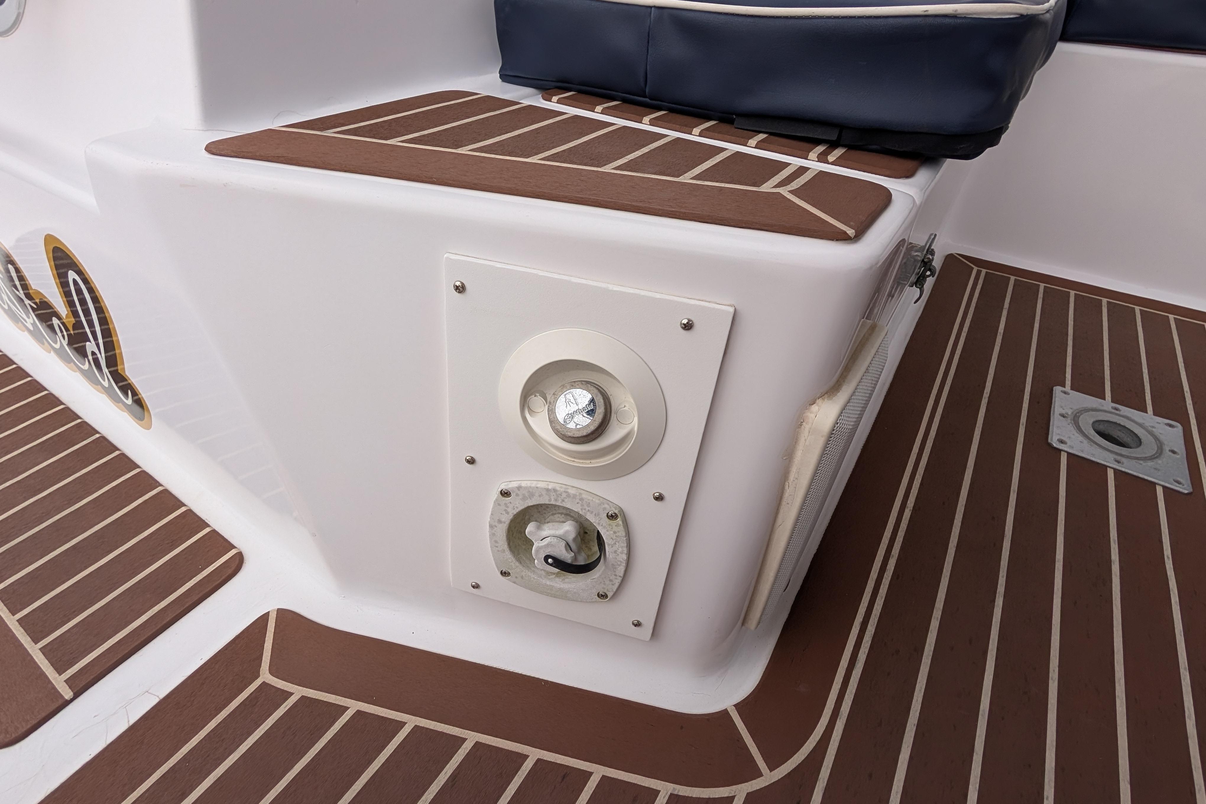 Deck area of a 1999 Island Spirit 37 sailboat with wood-patterned flooring.
